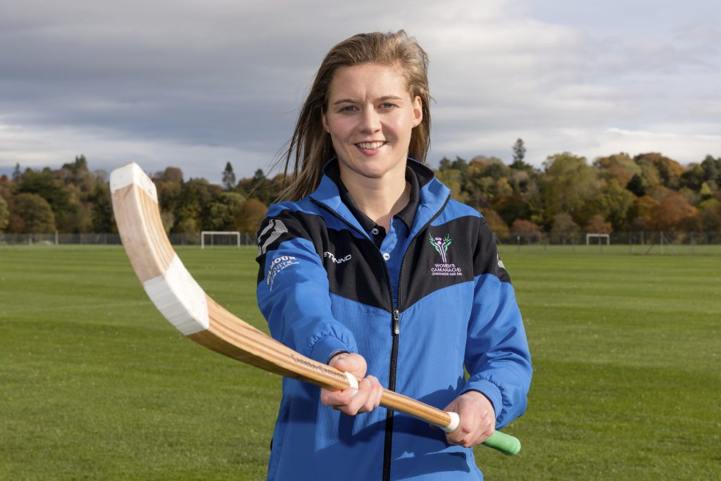 Kirsty Deans, holding a shinty caman.. Image credit: Camanachd Association