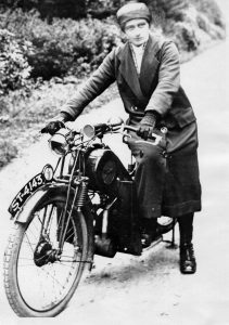 District nurse Flora Ferguson astride her motorbike.