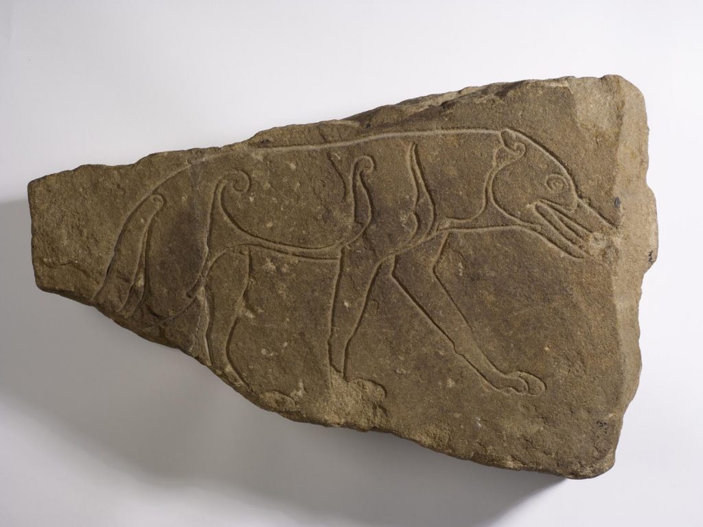 Pictish symbol stone featuring a carved outline of a wolf
