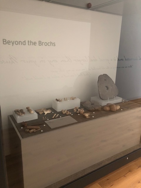 A museum display case titled “Beyond the Brochs” showing stone tools and small artefacts.