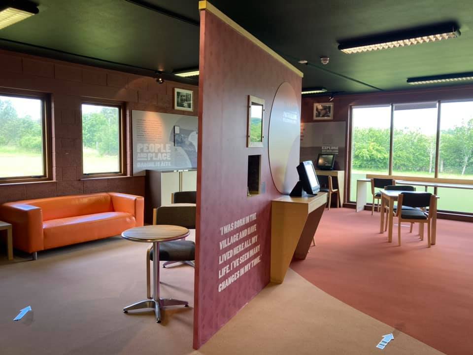 Visitor centre room with seating areas, large windows, and an information panel titled ‘People and Place.