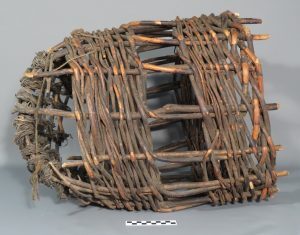 A rounded, open-ended basket trap made from woven sticks.