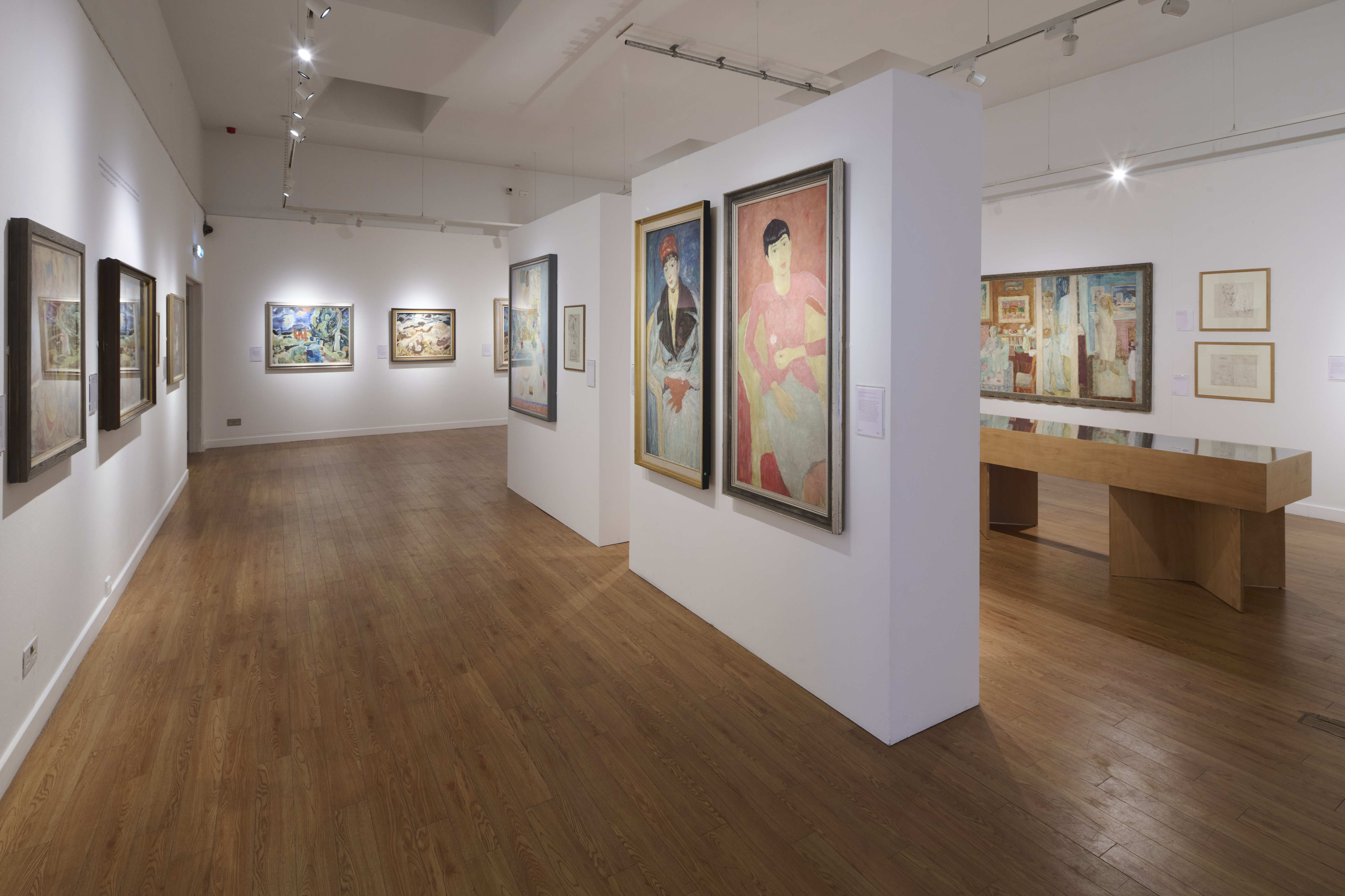 An art gallery with white and paintings