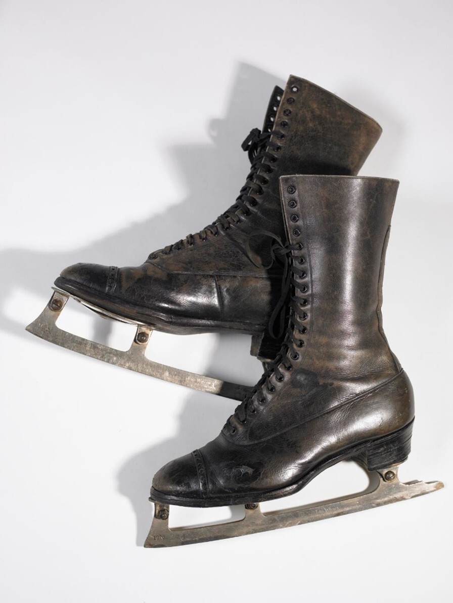 A pair of black ice skates on a white background.
