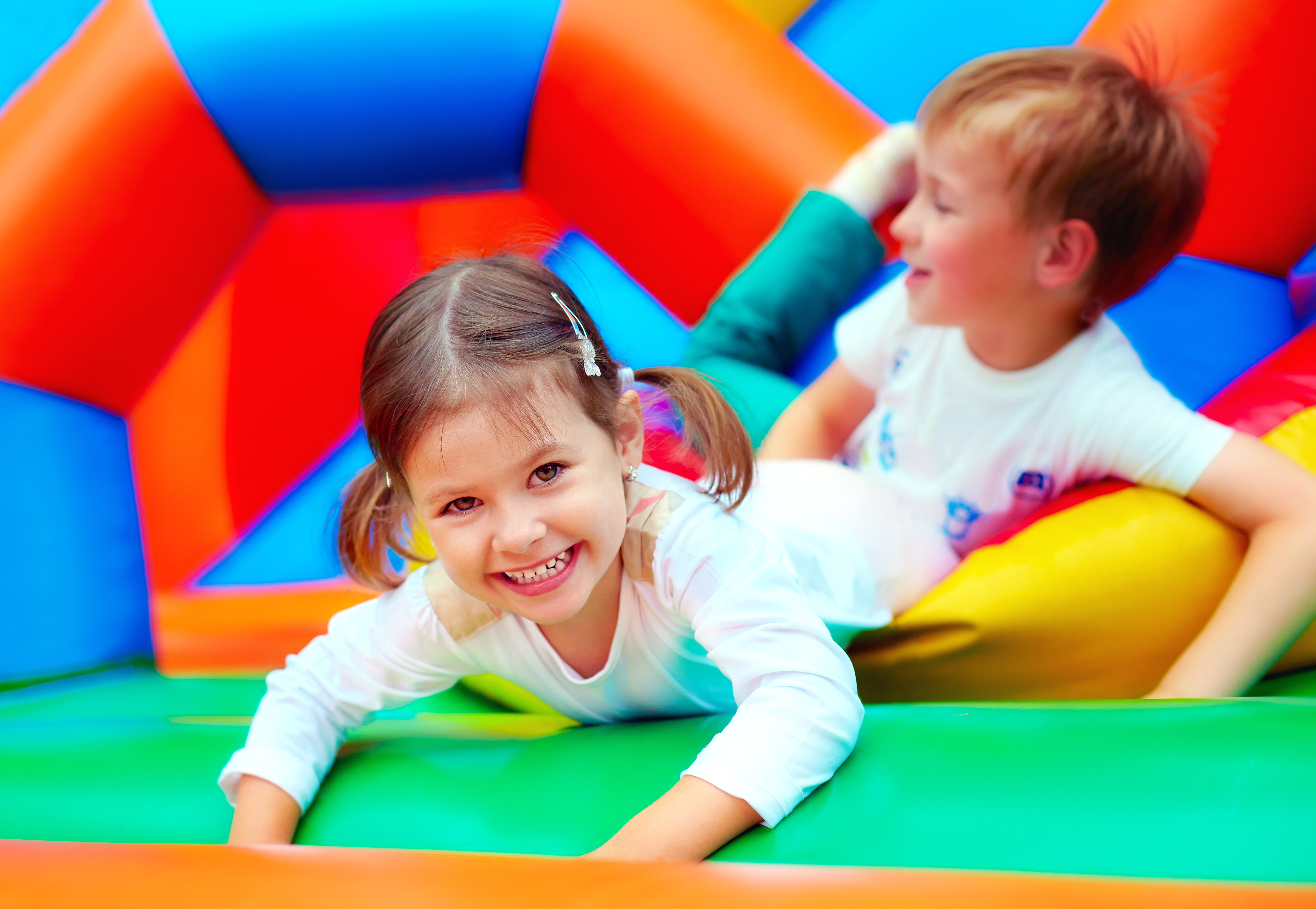 Children playing in a bouncy castle