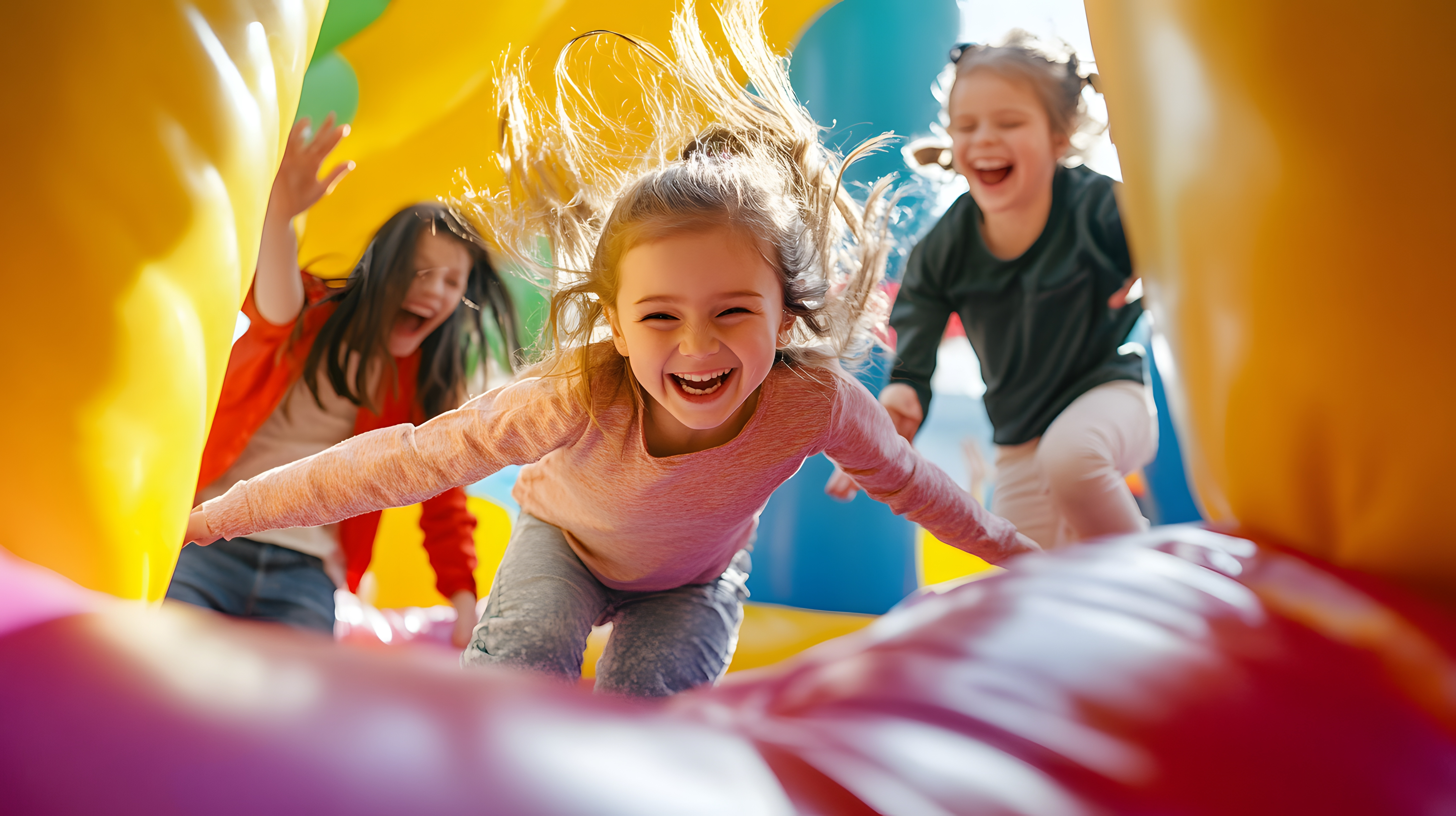 Children playing in a bouncy castle.