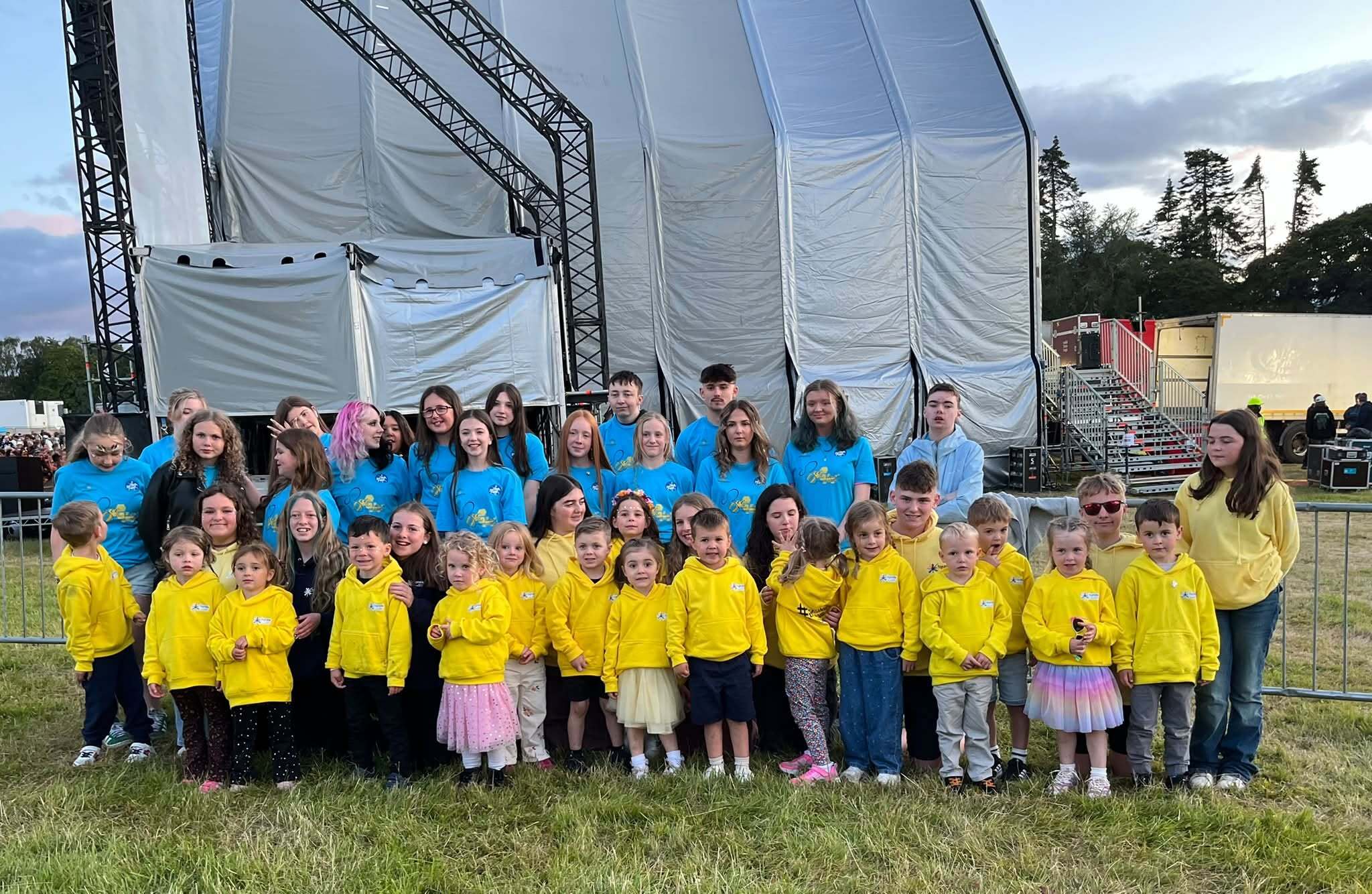 Bee The Change choir members in front of the Belladrum stage