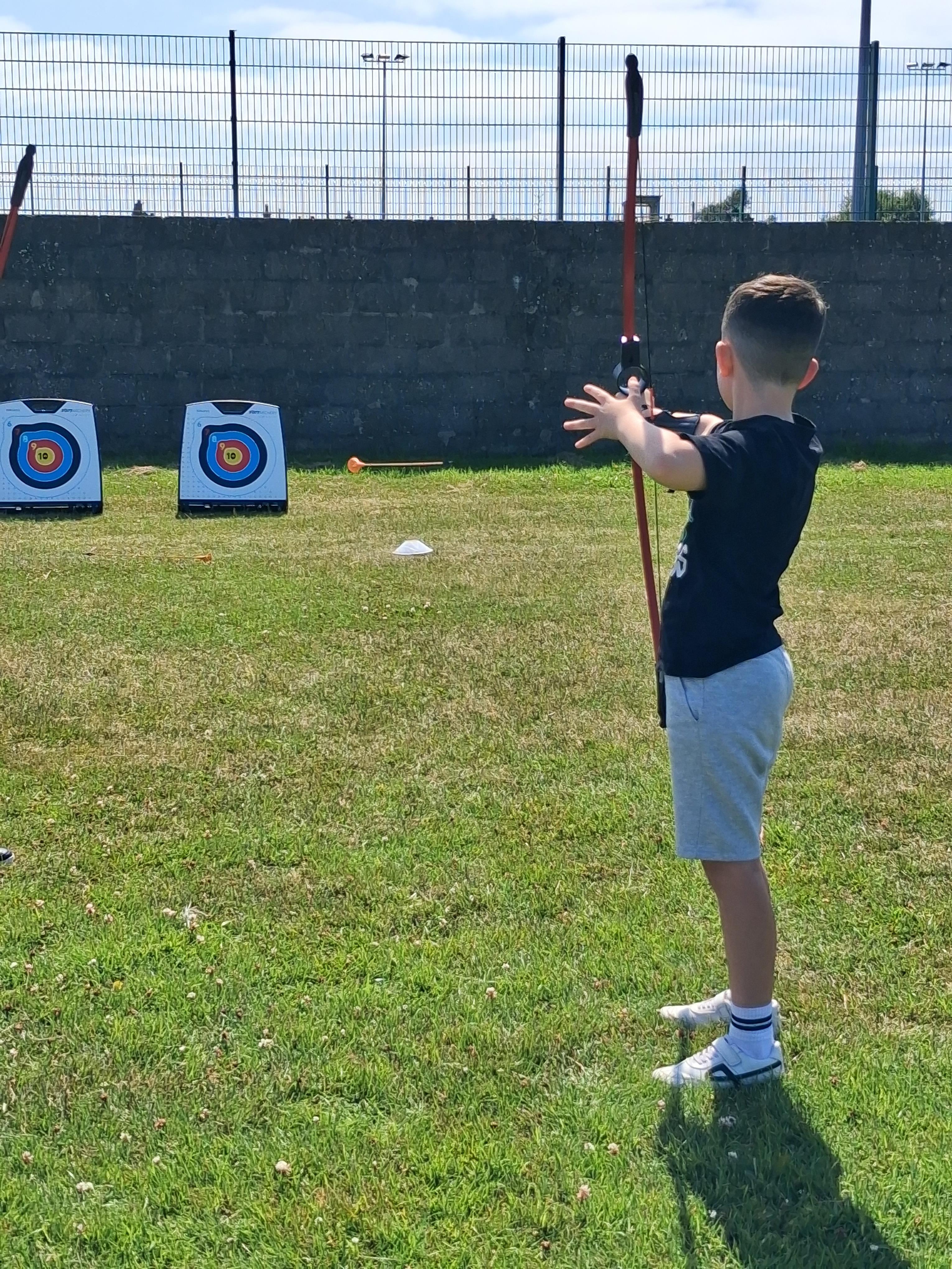 Boy taking aim during an archery session