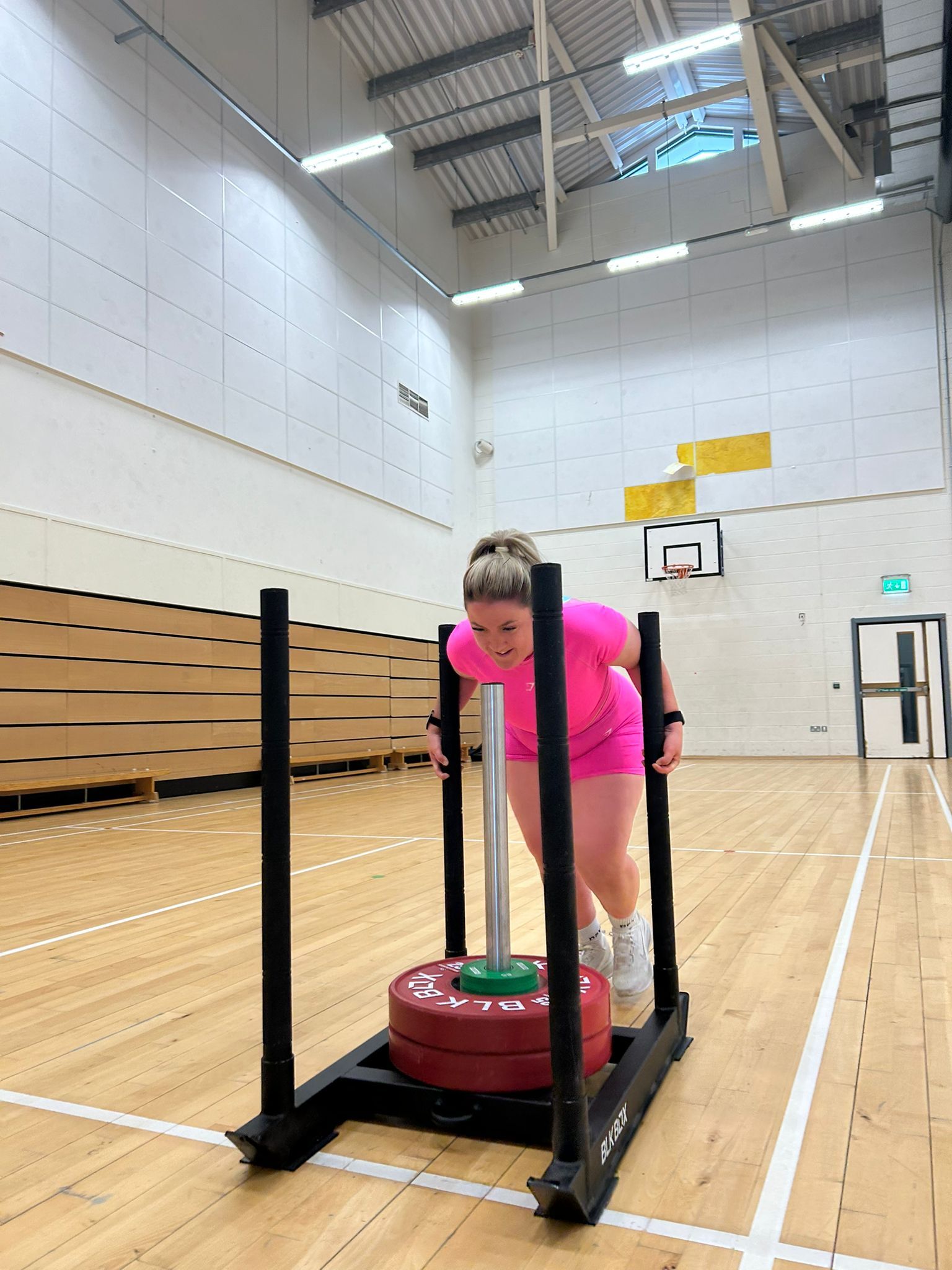 (Aviemore Sim)	Woman pushing sled during HYROX Sim at Aviemore