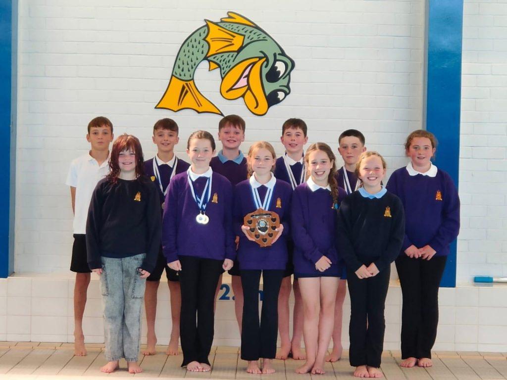 Pupils from ESSSA pose with medals and a trophy at the Sutherland Swimming Pool during a recent swimming gala.