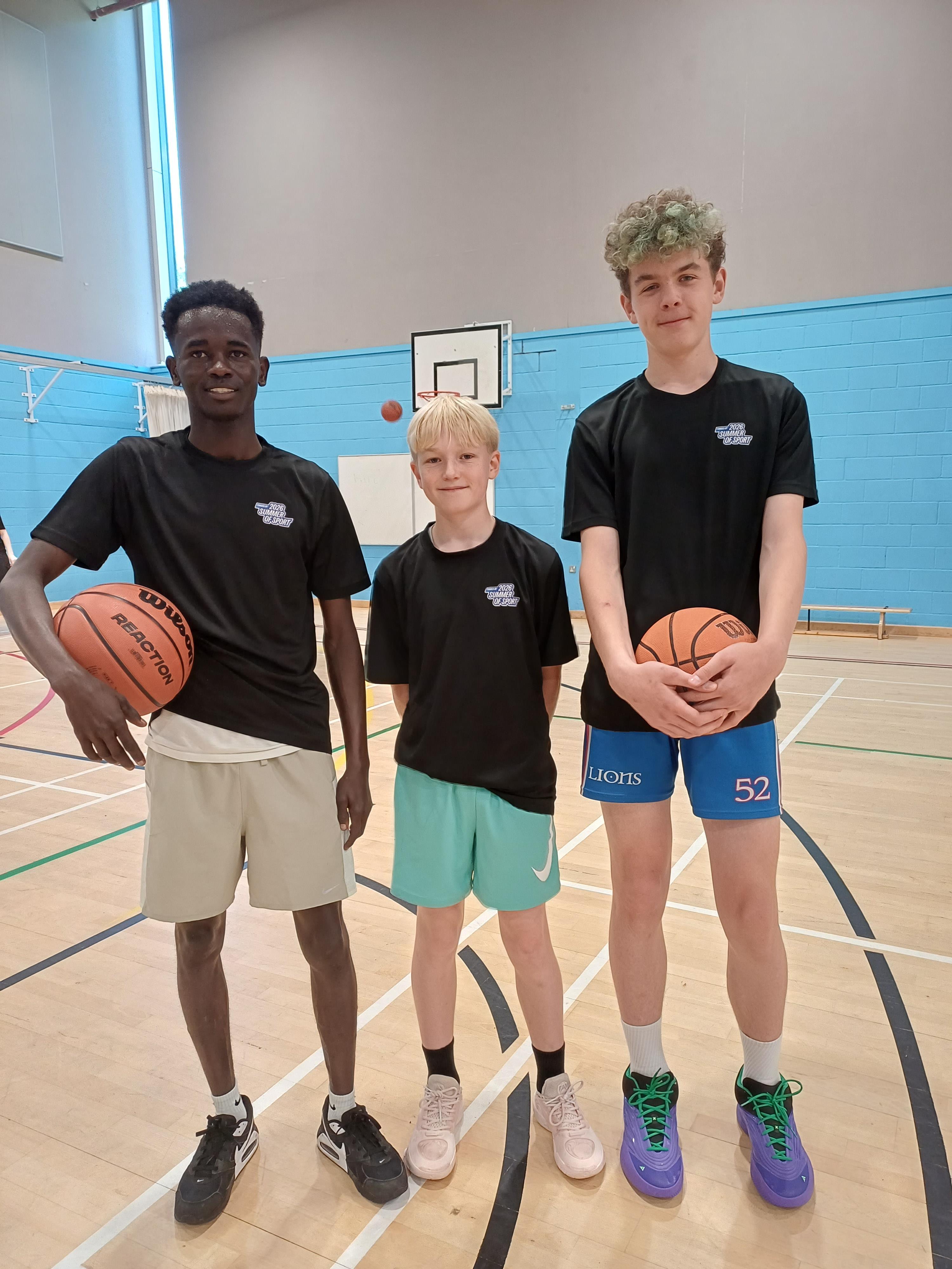 Three Hoops Without Borders participants with basketballs