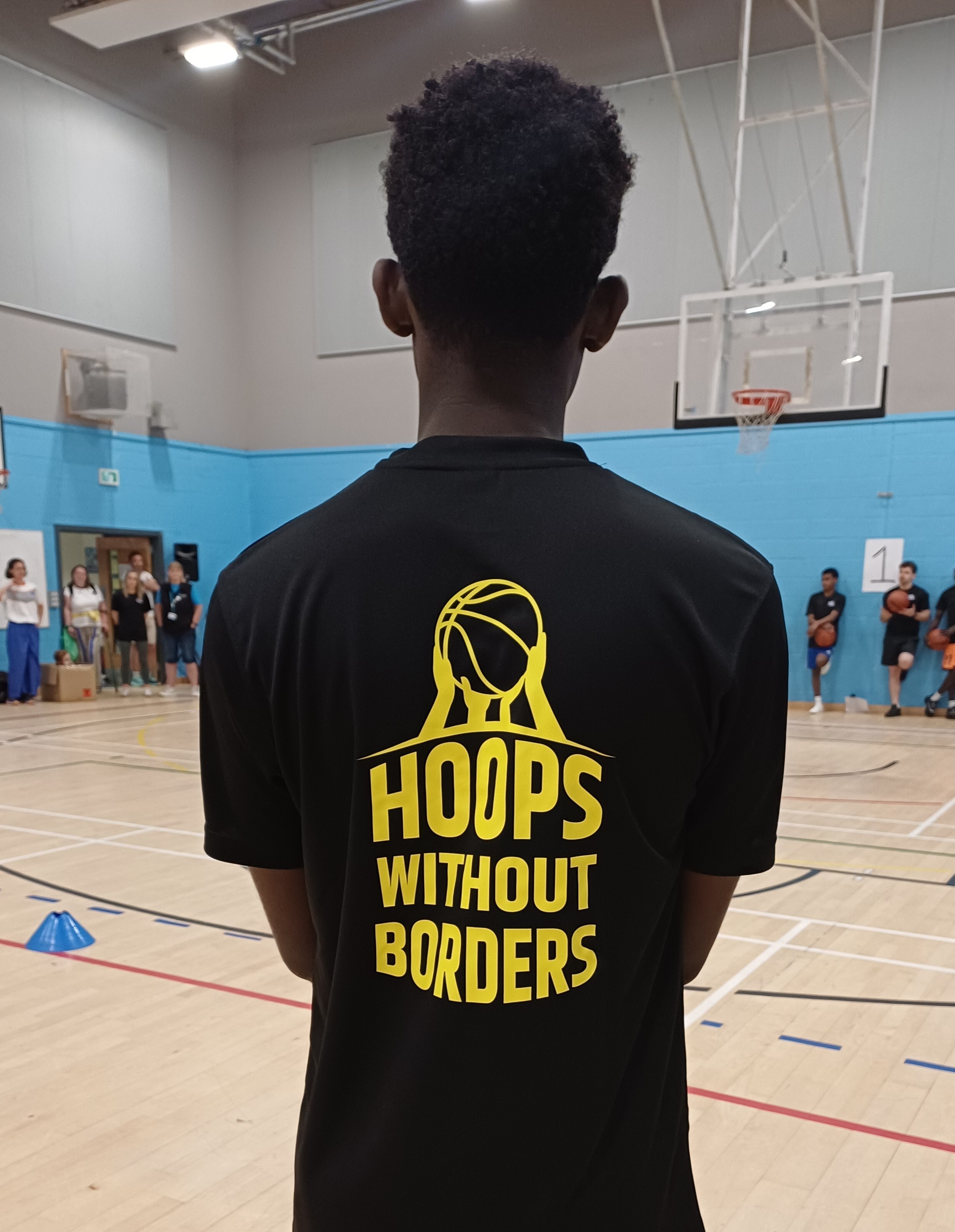 Young man wearing a Hoops Without Borders t-shirt