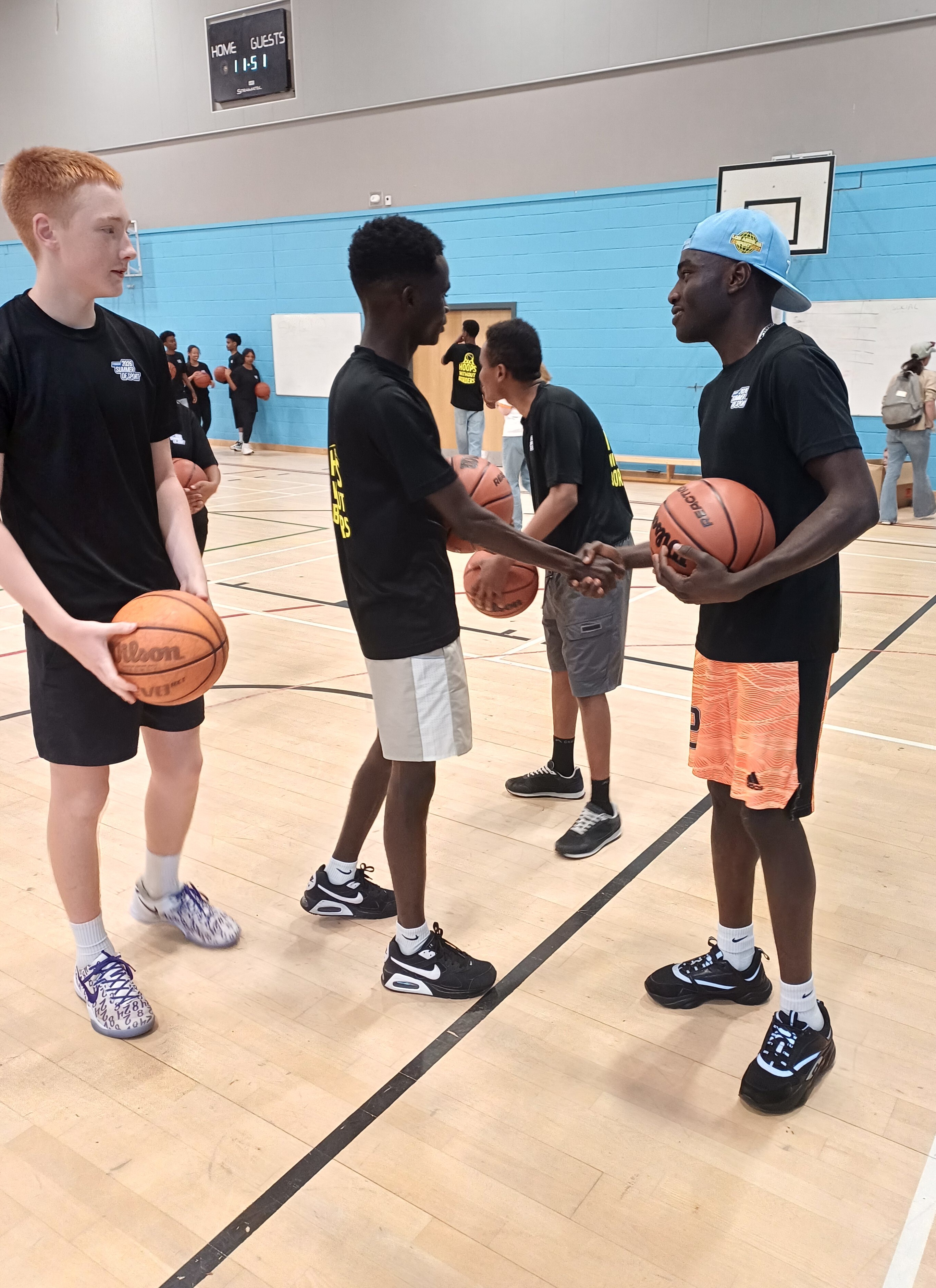 Two young basketball participants shaking hands