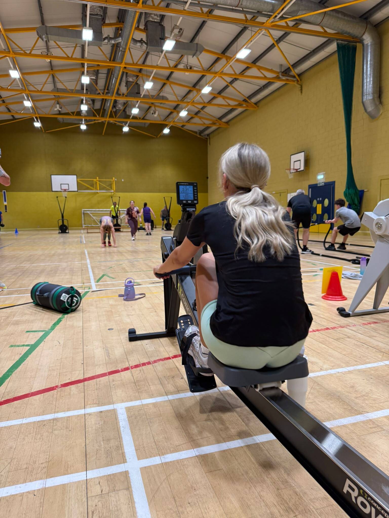 Woman rowing on indoor rowing machine