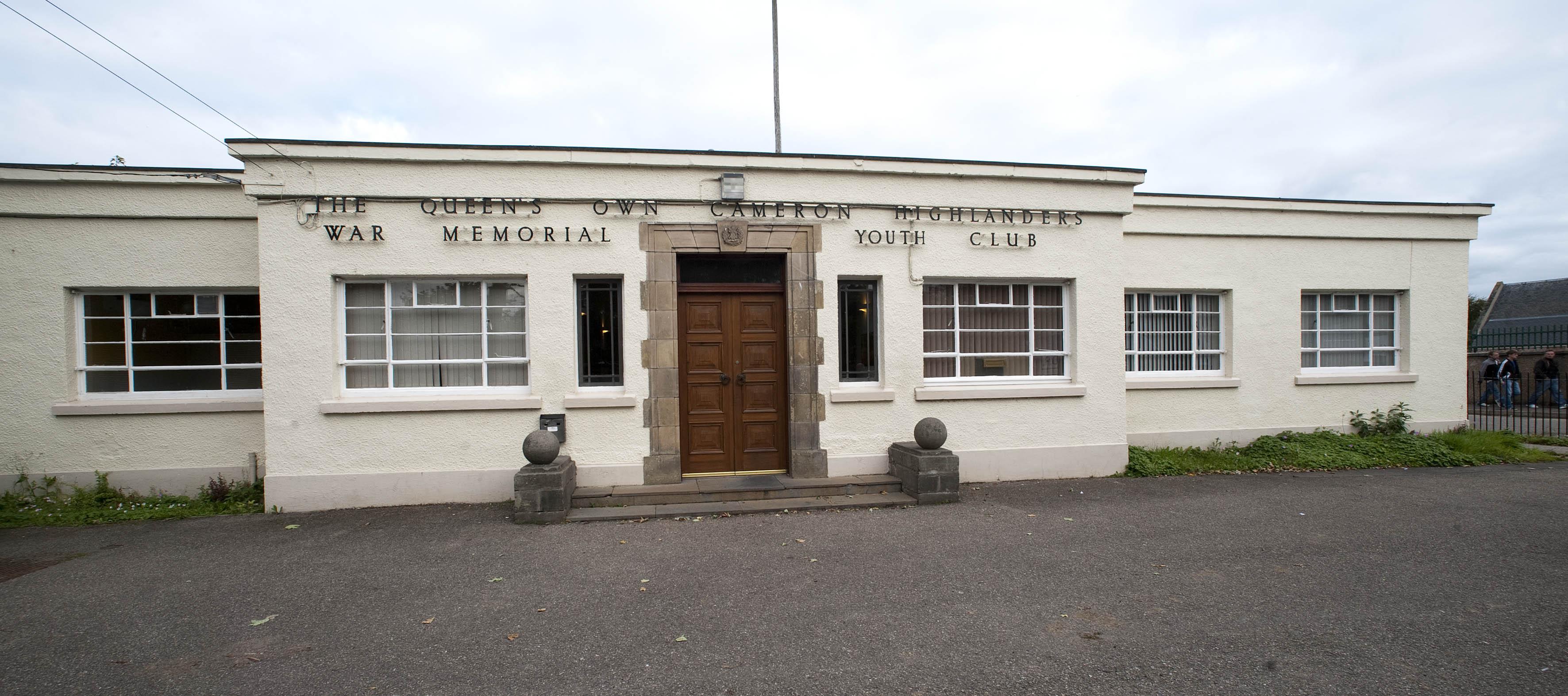 A white, single-story building featuring two steps that lead up to the main entrance.