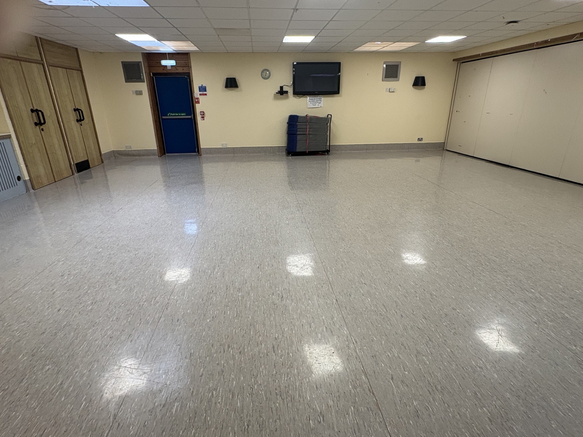 The Graham Ross Suite 2 is a spacious room characterised by laminated flooring and stone walls.