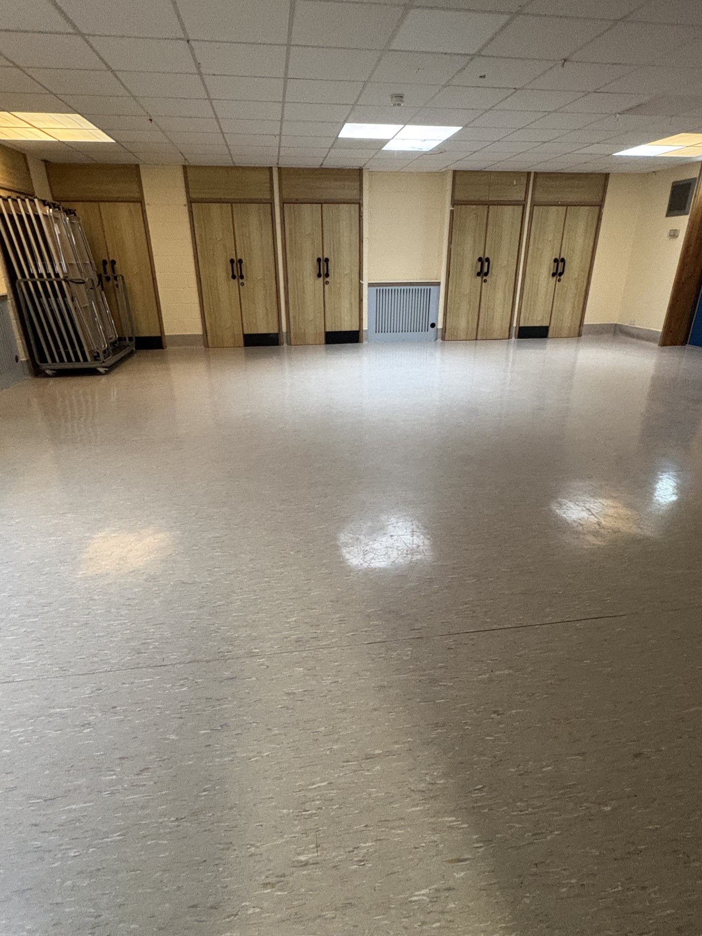 The Graham Ross Suite 2 is a spacious room characterized by laminated flooring and elegant stone walls.