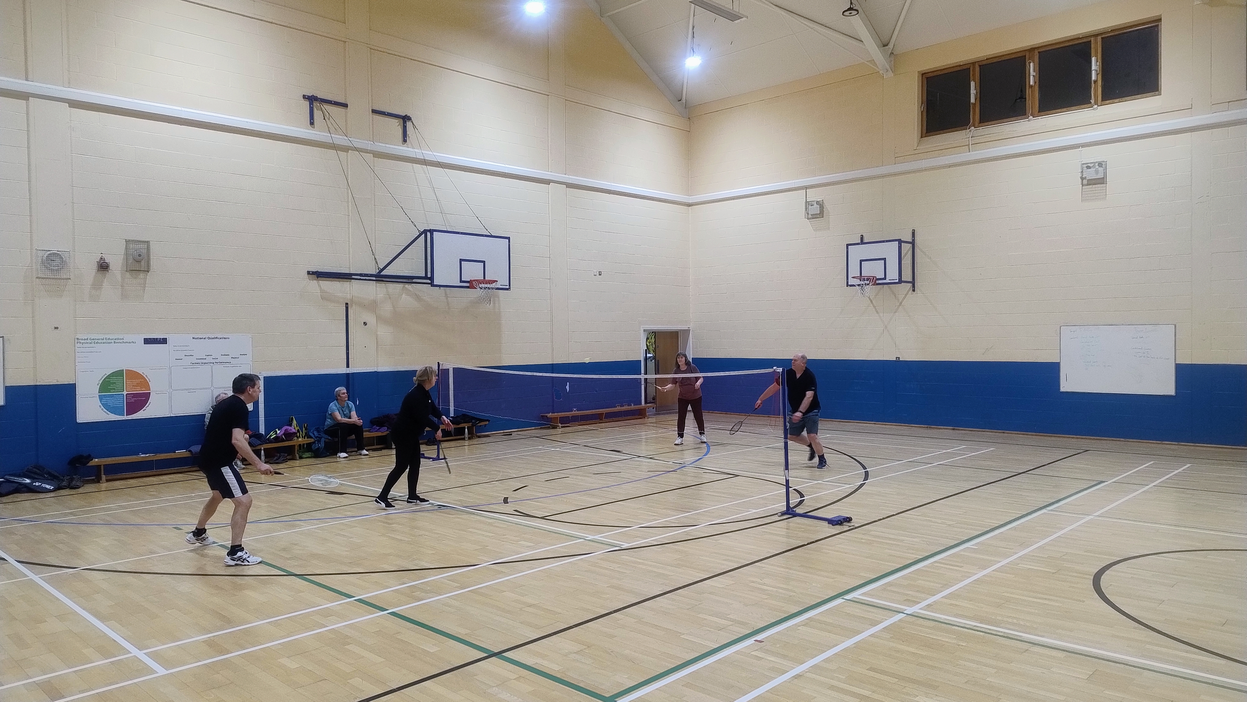 A Games Hall featuring court markings for both basketball and badminton on the floor, along with multiple basketball hoops mounted on the walls.