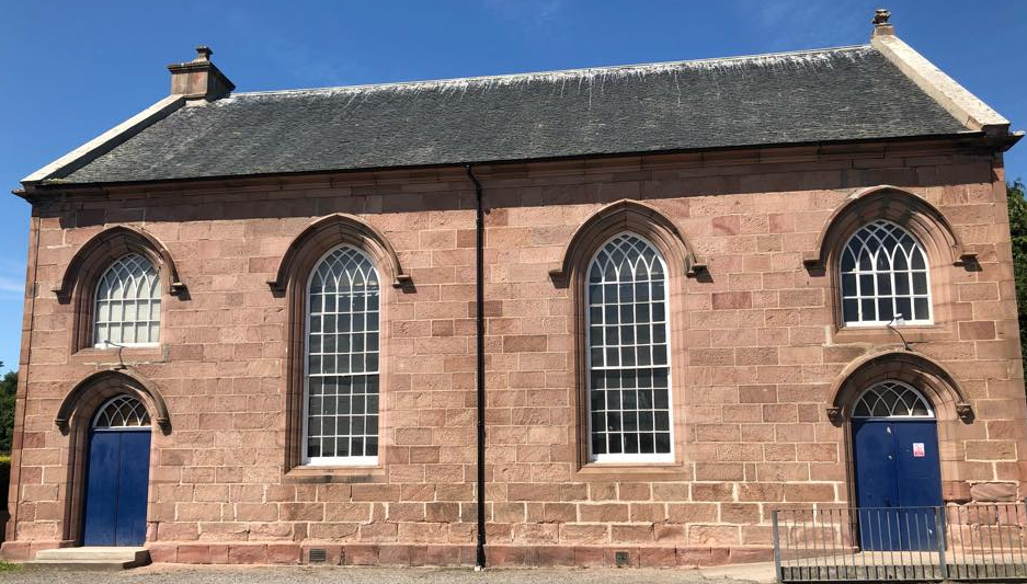 A charming building featuring large, paned windows and 2 accessible entrances.