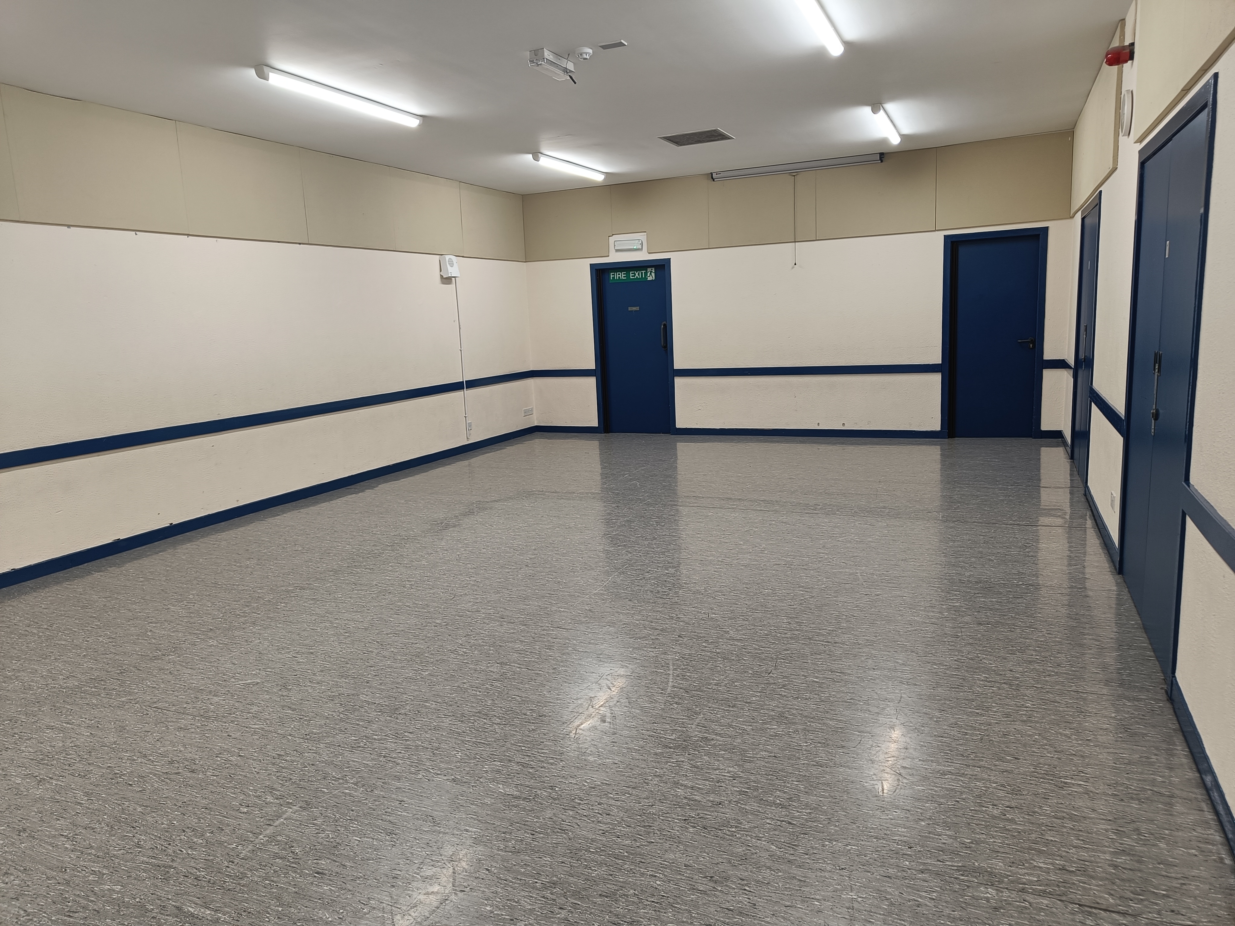 A bright and spacious room featuring linoleum flooring.
