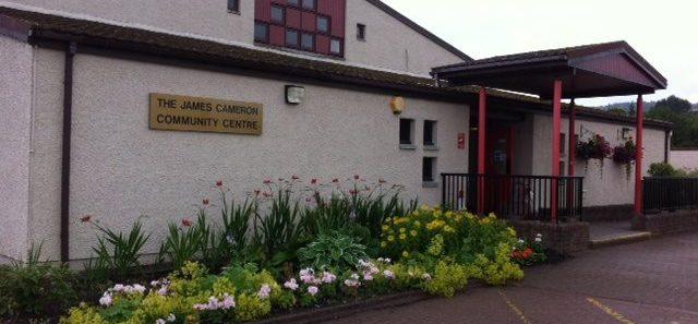 A contemporary building featuring a porch roof that extends over the main entrance, which is accessible via a single step.