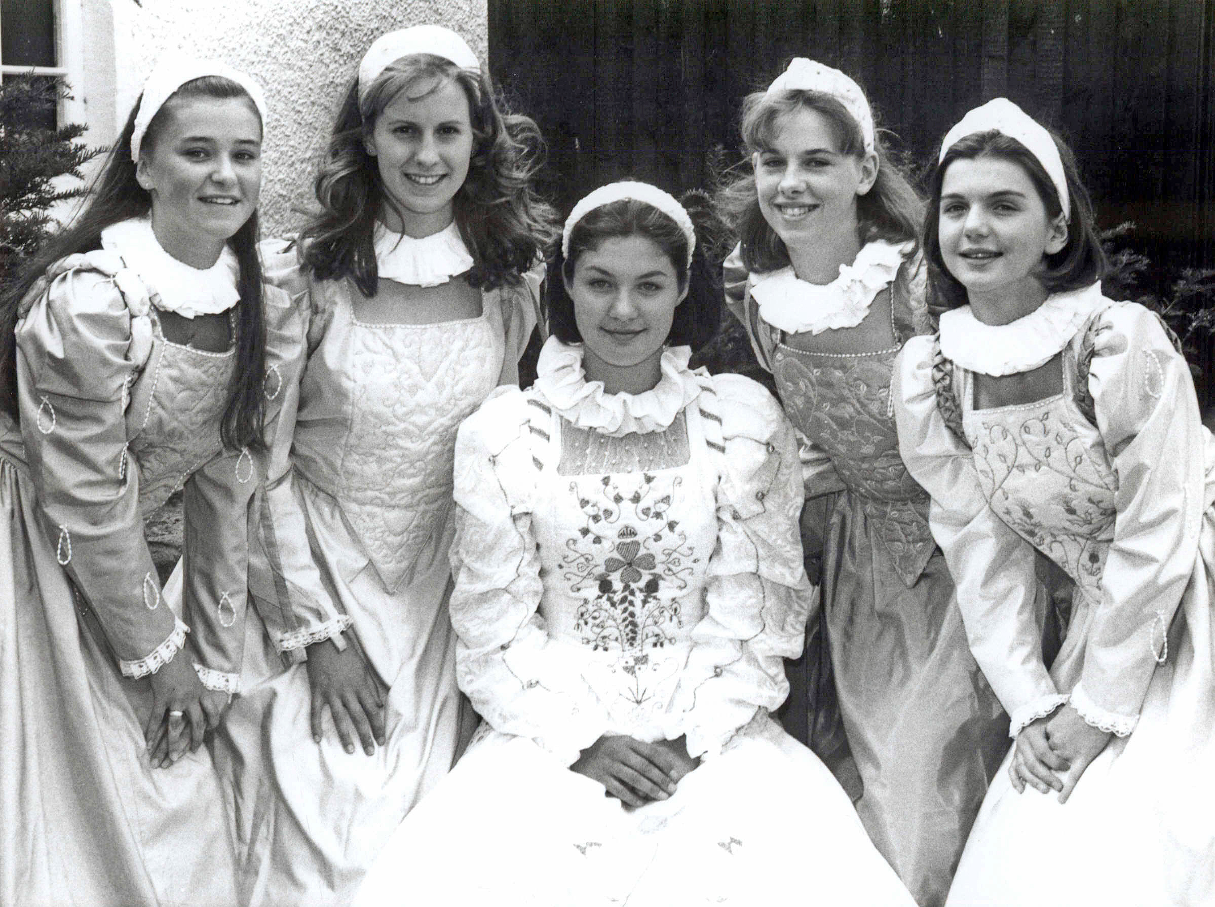 Black and white photograph of five young women in historical costumes at the Marymas Fair, around 1993.