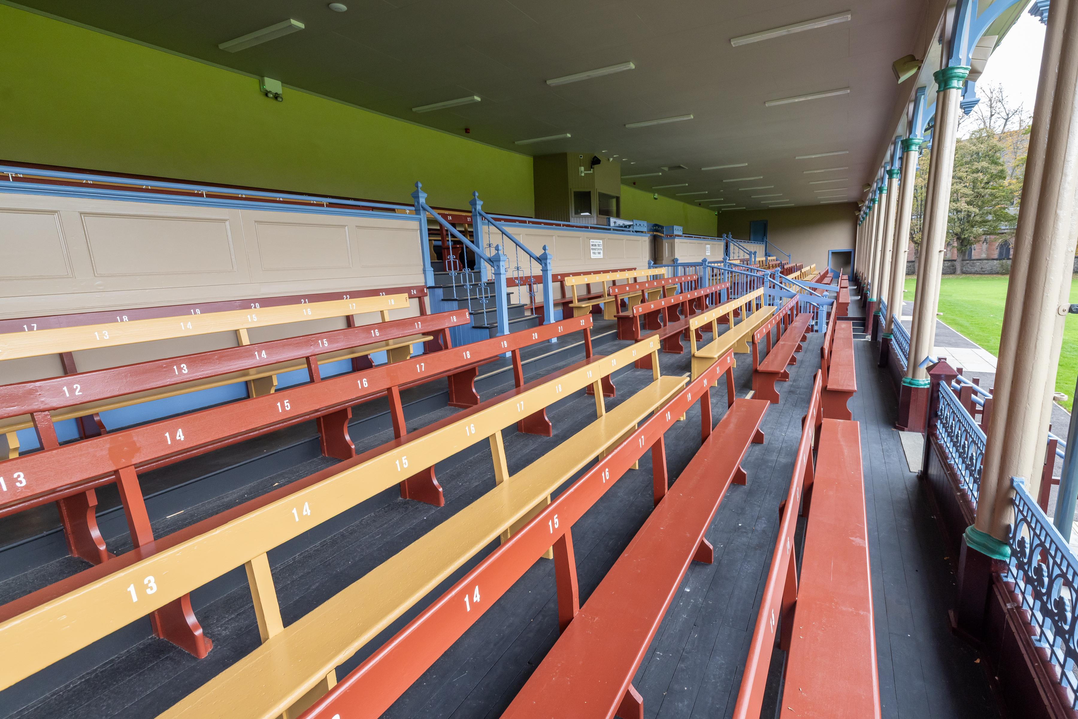 Vibrant grandstand stadium seating overlooking a grassy area.