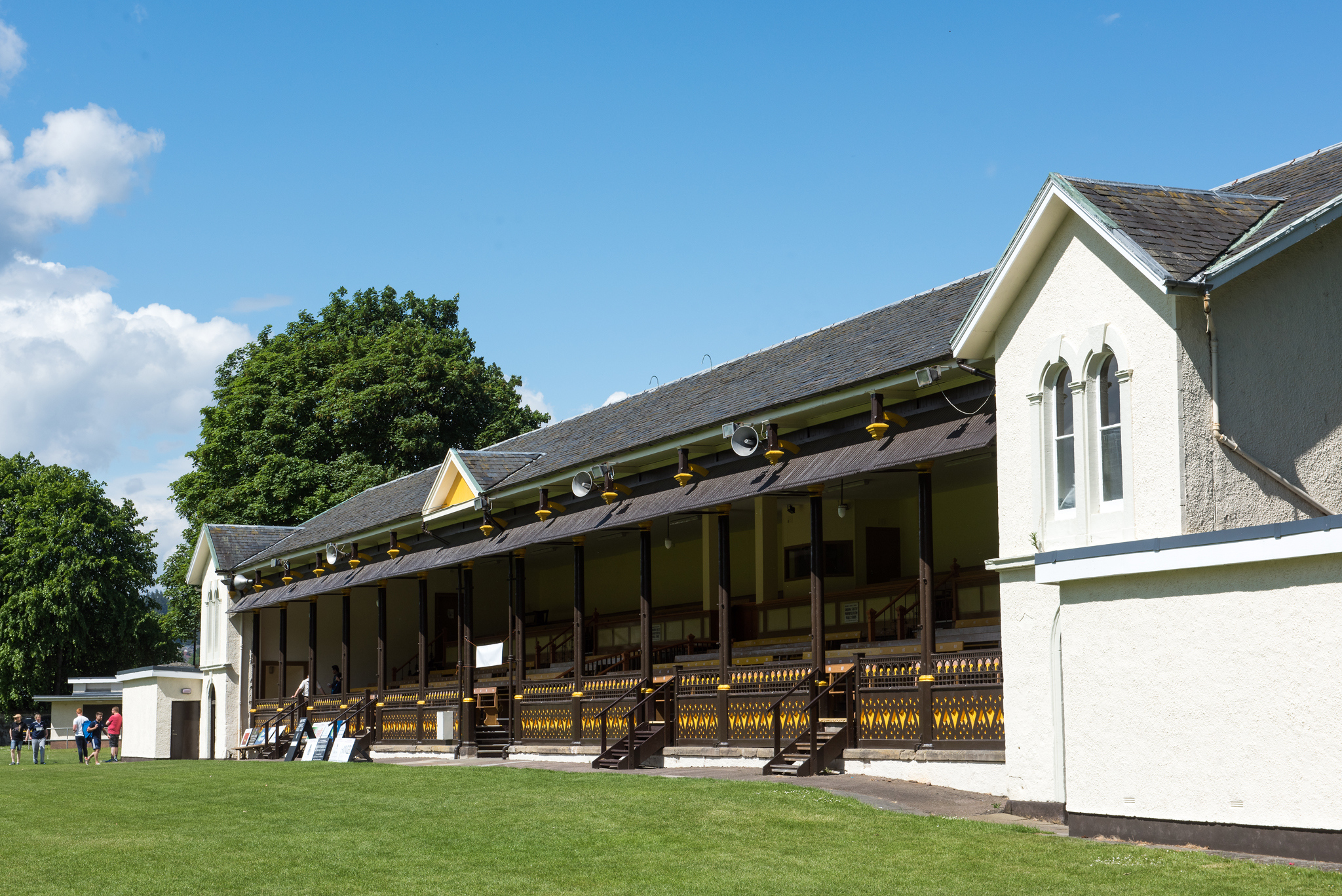 A Victorian grandstand overlooking the grassy expanse.