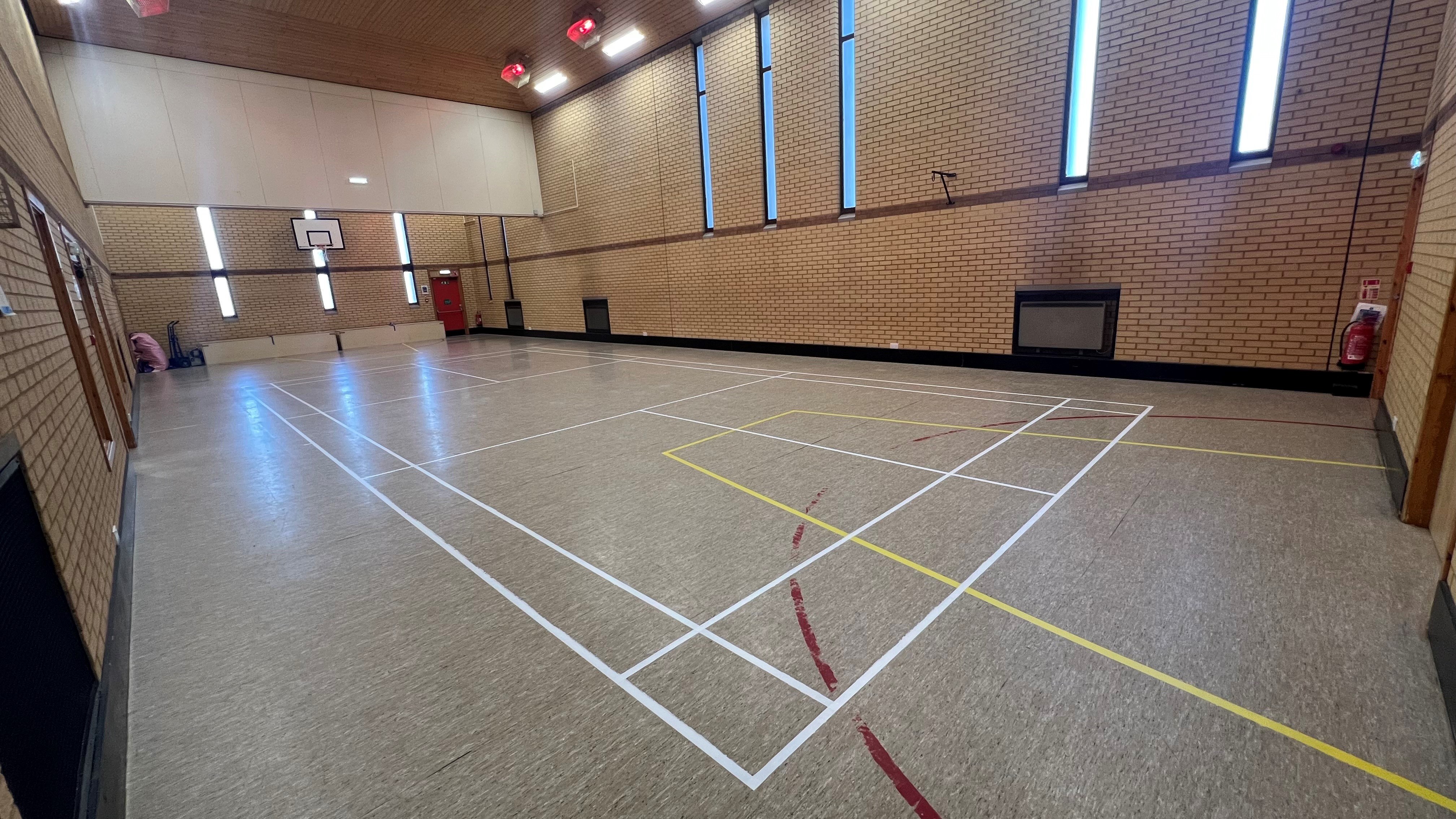 The Ashton Room is a spacious hall that includes floor markings designed for a basketball court, complete with basketball hoops at each end.
