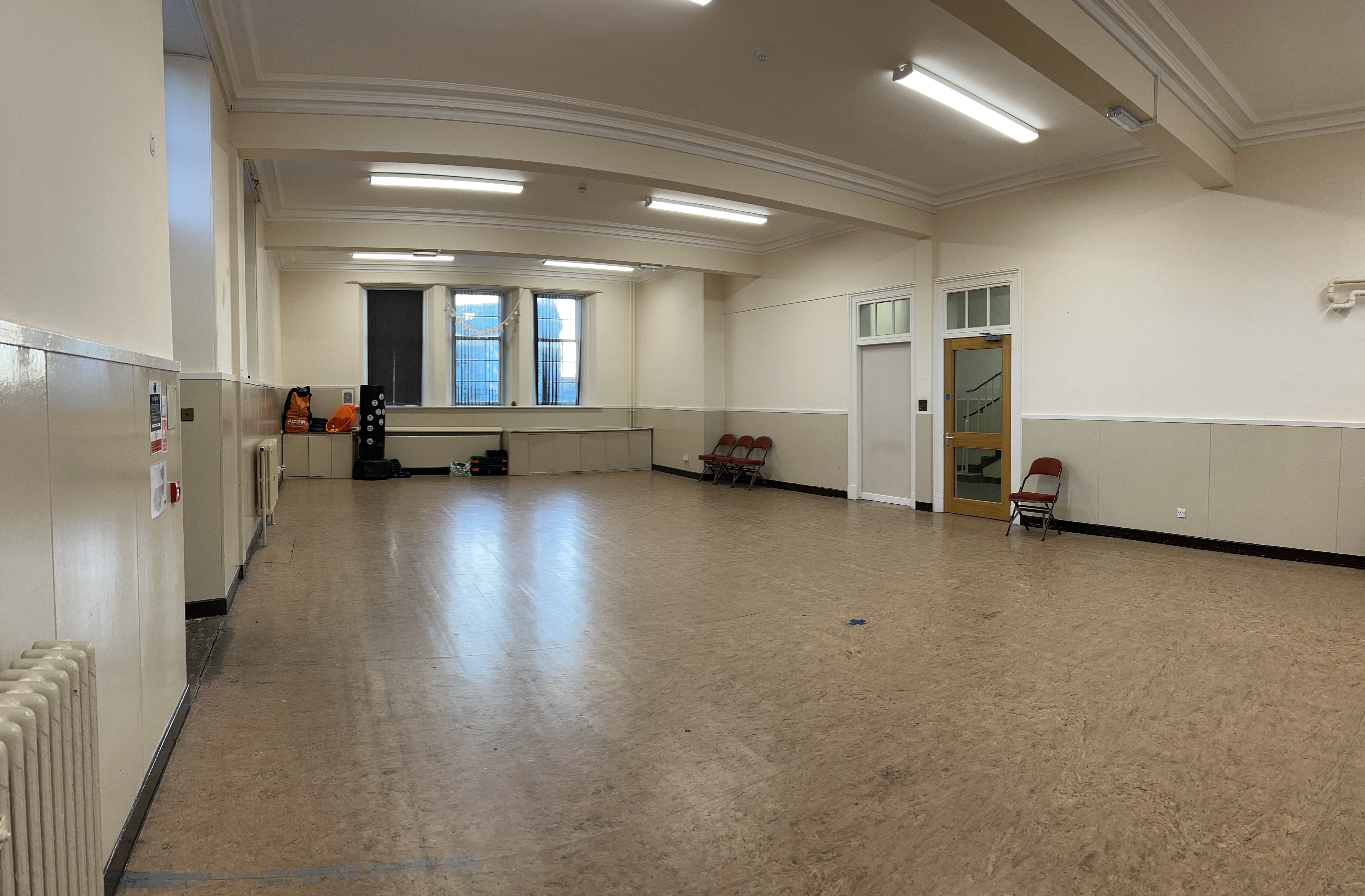 A well-lit, spacious hall featuring linoleum flooring.
