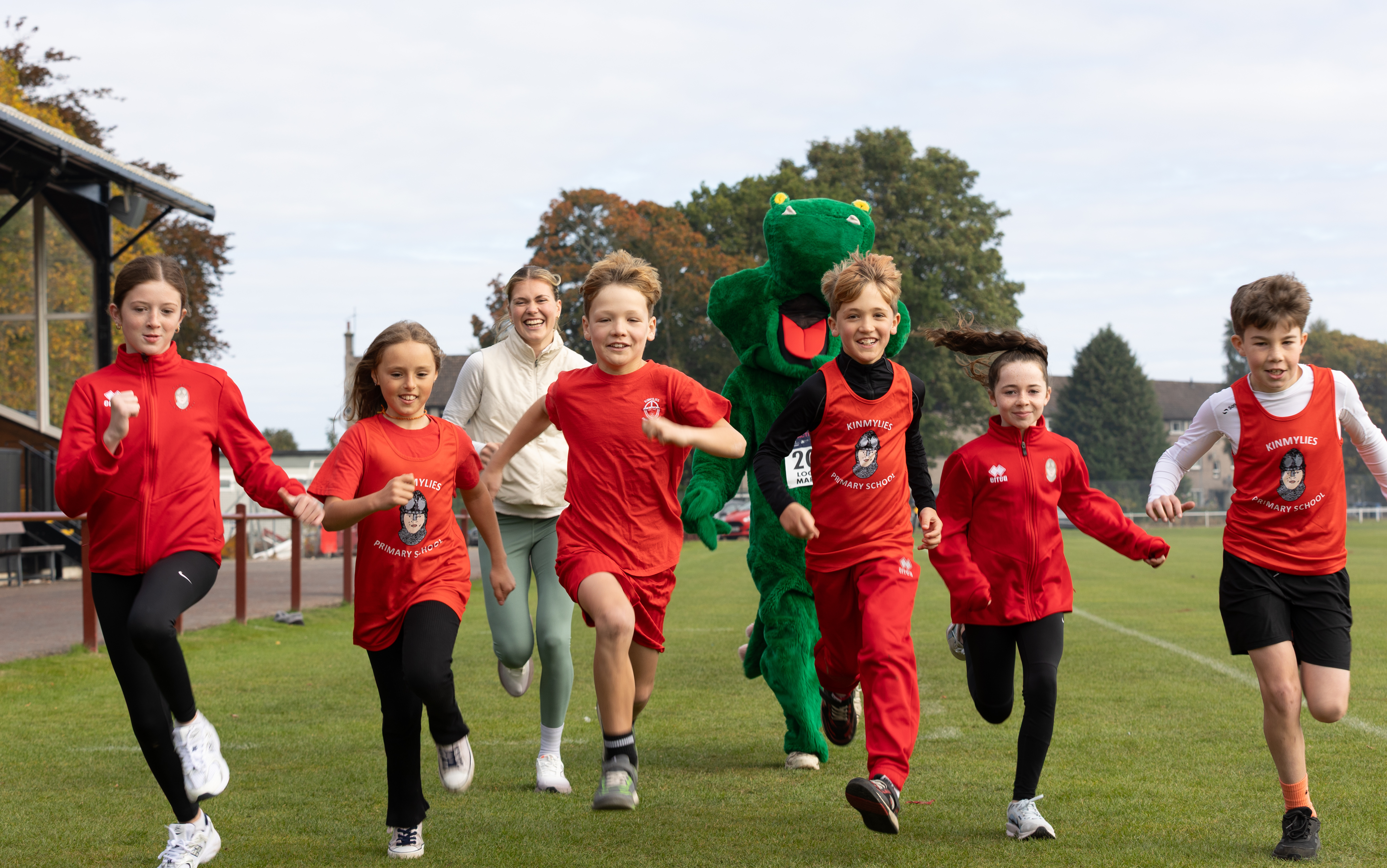 Kinmylies Primary pupils running with Megan Keith in Bught Park.