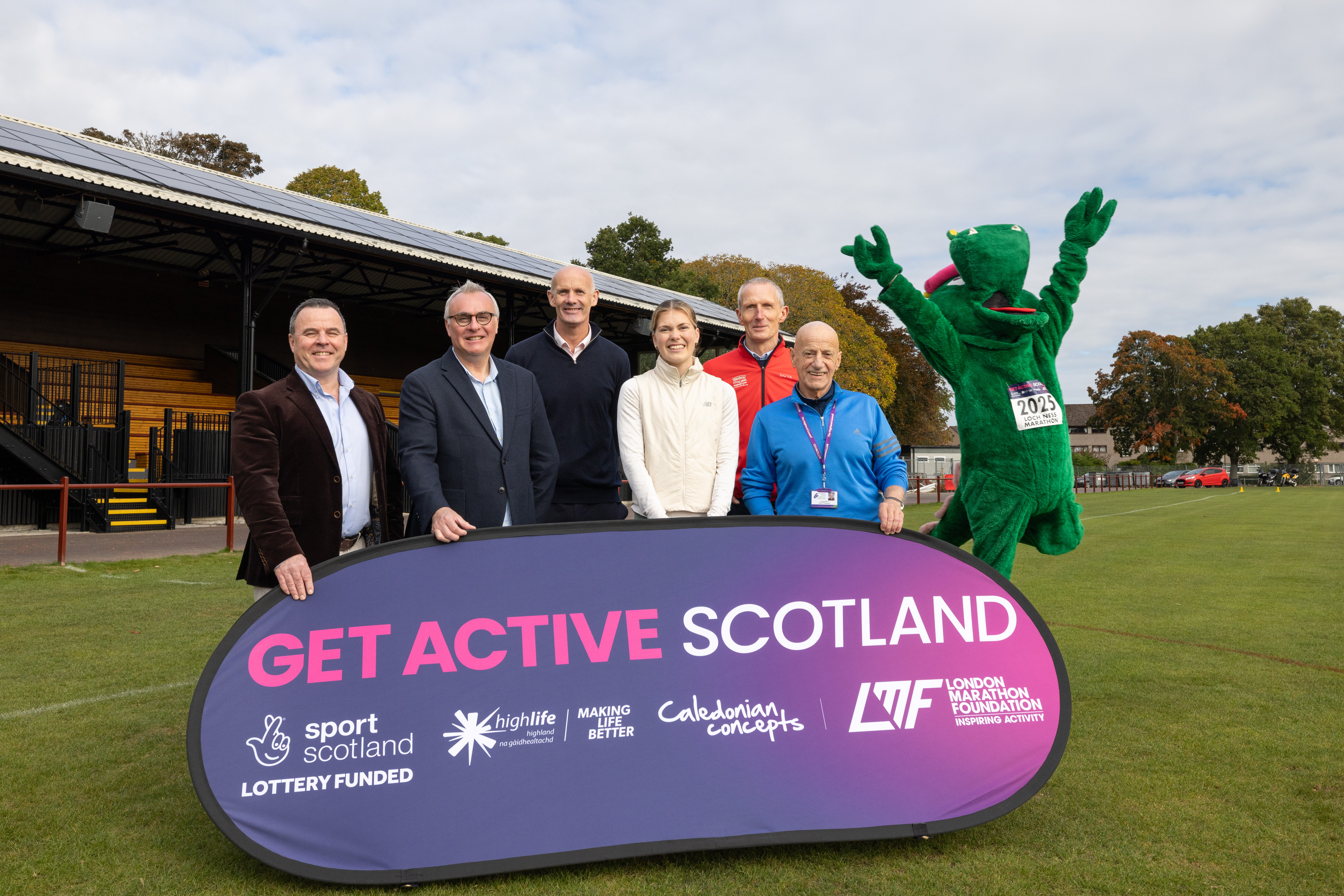 A group of children lined up on a sports field, ready to start a race.