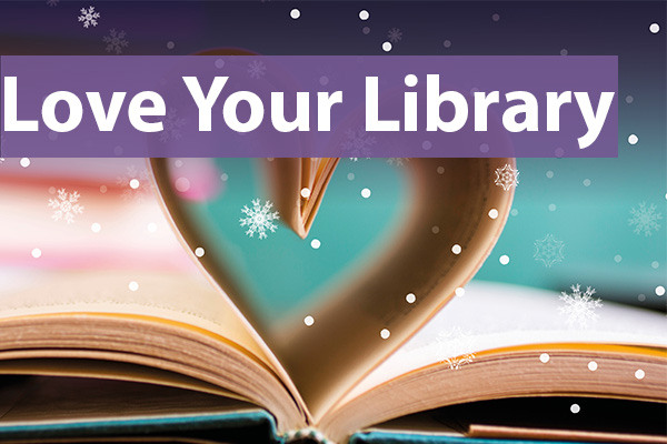 An open book with its pages folded into a heart shape, with falling snowflake graphics and the words “Love Your Library” in bold purple text across the top.