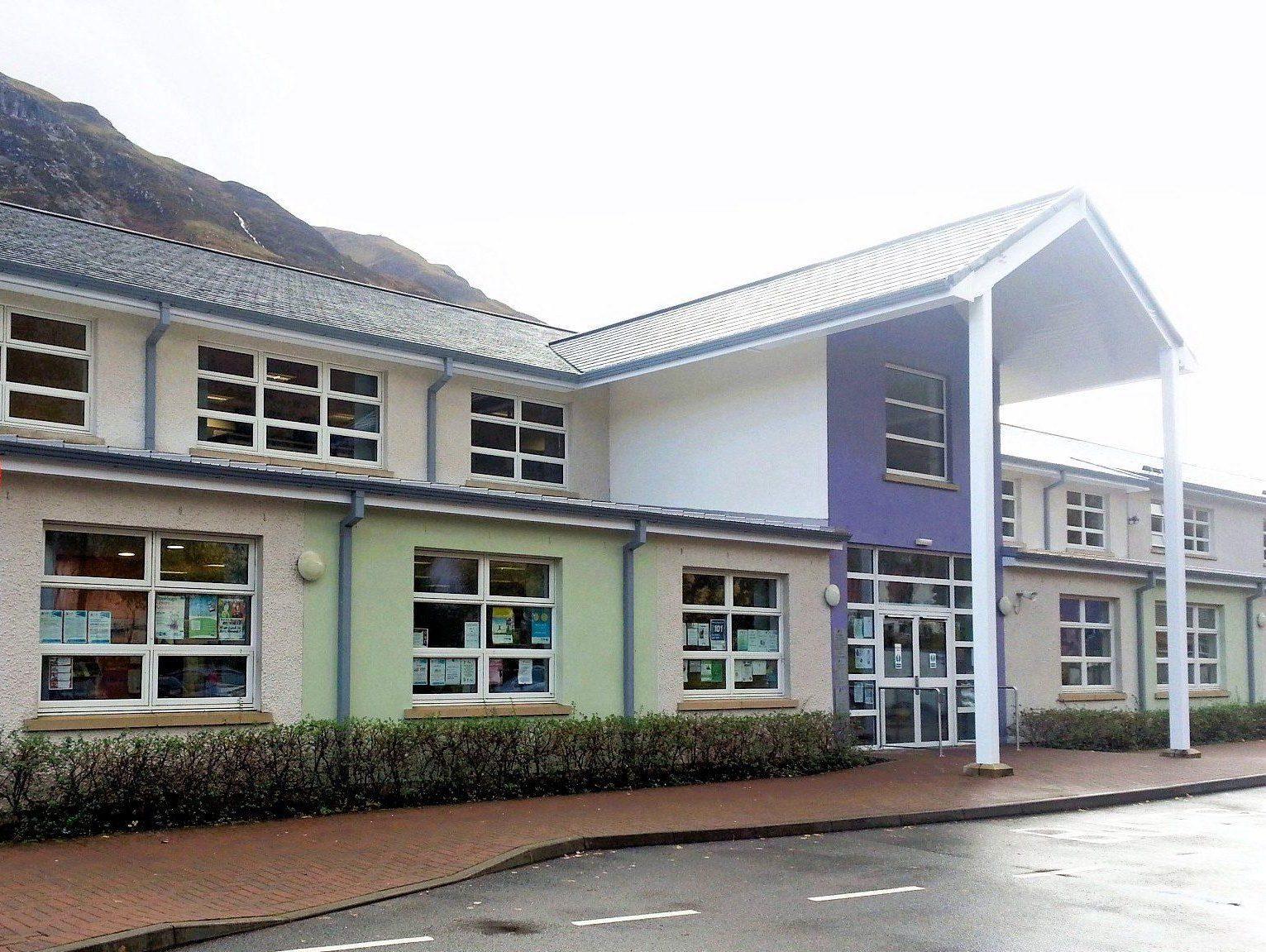 Front of Kinlochleven Library, modern two-storey building with pastel walls, large windows, and a covered entrance.
