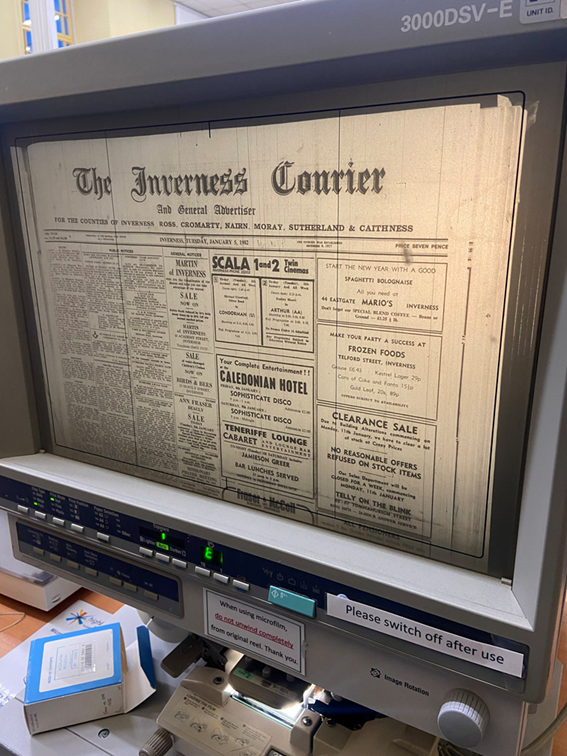 A microfilm reader displaying a scanned page of the Inverness Courier newspaper. The machine shows the enlarged newspaper page on its screen, with controls and instruction labels visible below.