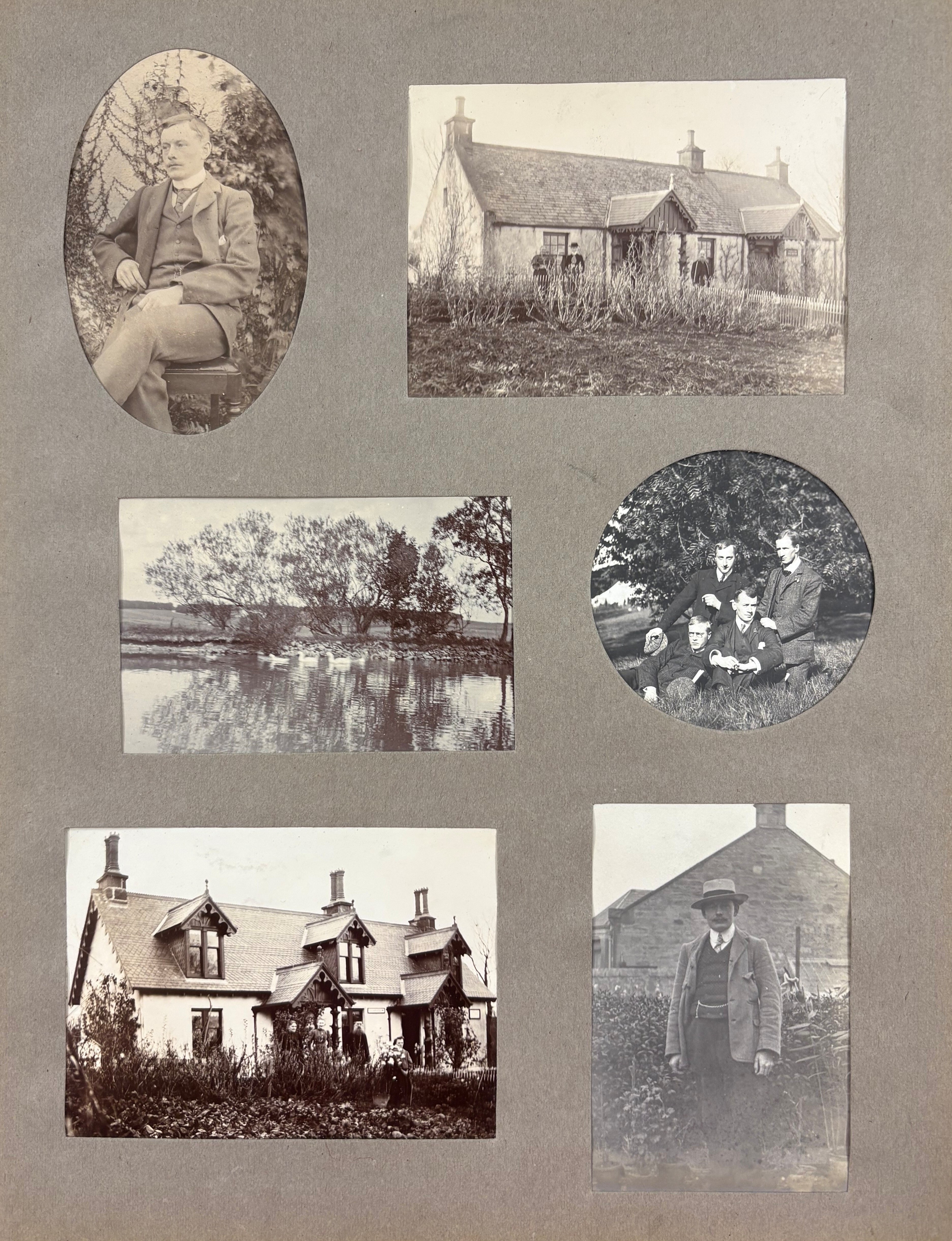 A scrapbook page featuring six black-and-white photographs arranged on a grey background. The images include: an oval portrait of a person seated on a wooden chair wearing a formal suit; a rectangular photo of a stone cottage with a pitched roof surrounded by tall grass; a scenic view of a calm river with trees reflected in the water; a circular photo of a group of five people sitting outdoors under a tree; a photo of a two-story house with dormer windows and a garden in front; and a rectangular photo of a person standing outside near a stone building, dressed in a jacket and hat.