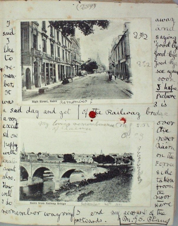 A page from a child's diary written in black ink and including two black and white postcards of Nairn