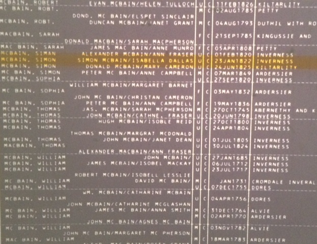 An image of a black microfiche with white typed text and an orange highlighted line