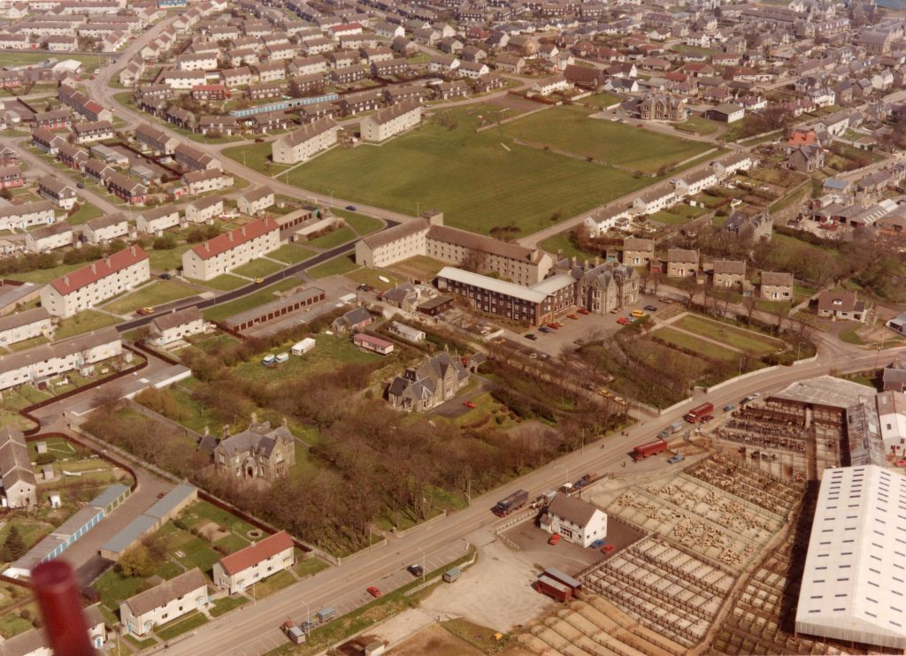 Aerial view of Ormlie area in Thurso showing housing blocks, green spaces, roads, and industrial buildings.