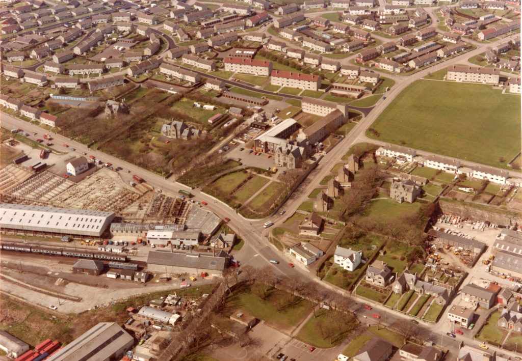Aerial view of Ormlie in Thurso showing housing estates, green spaces, roads, and industrial buildings.