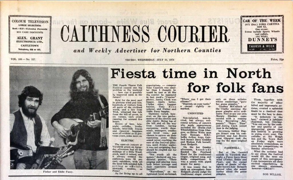 Front page of the Caithness Courier newspaper dated Wednesday, July 31, 1974. The headline reads ‘Fiesta time in North for folk fans.’ The page features an article about the Fourth Thurso Folk Festival, describing events, performers, and festival highlights. On the left side, there is a black-and-white photograph of two musicians playing guitars. Advertisements appear at the top corners: one for color television from Alex Grant Electronics Ltd., Castletown, and another for ‘Car of the Week,’ a 1971 Ford Cortina from Dunnet’s in Thurso and Wick.