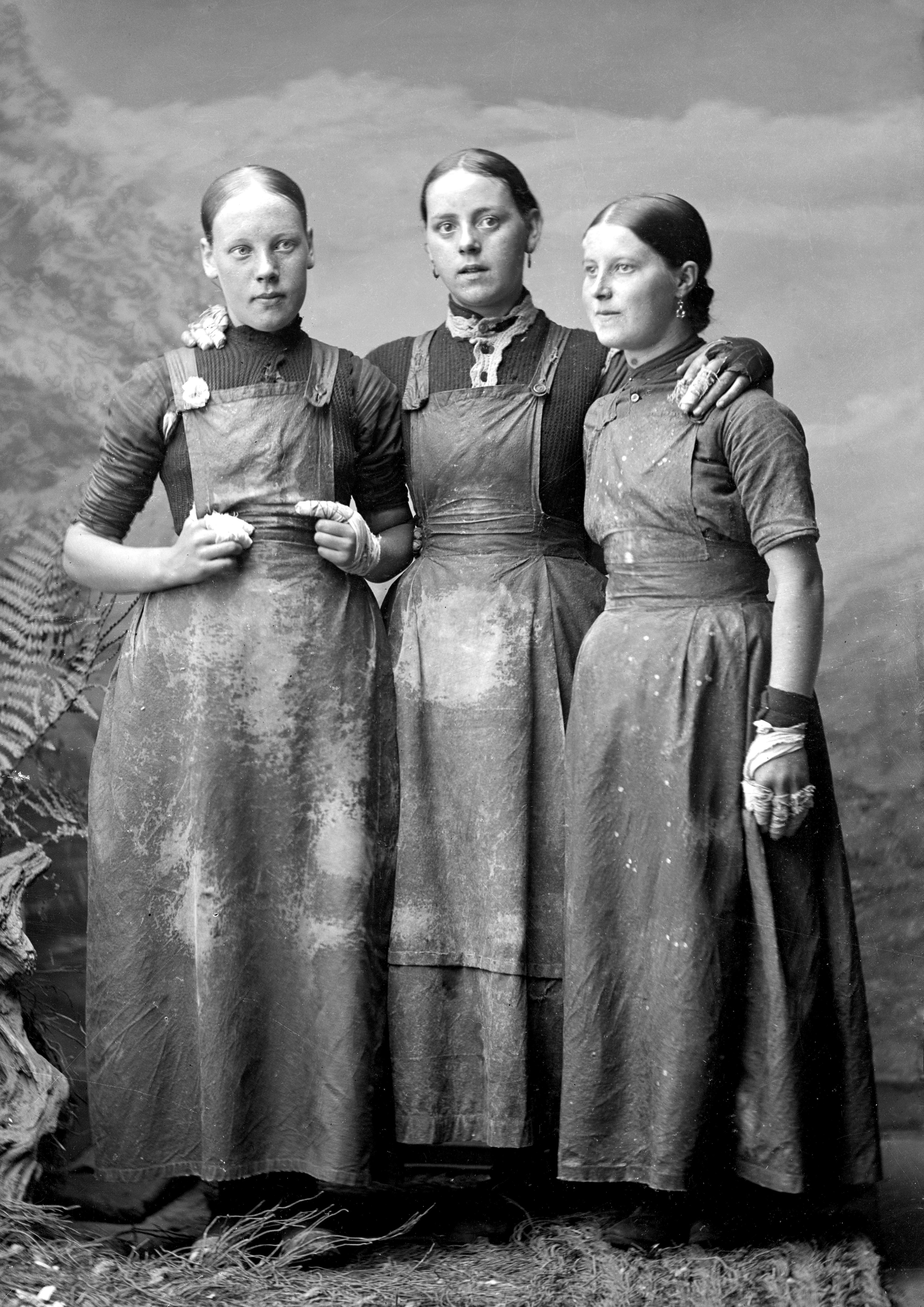 Portrait photograph of three herring gutters c.1890 , taken by Johnston Photographers Wick. This photograph illustrates how the gutters would wrap their fingers in strips cut from flour sacks to protect them from cuts .