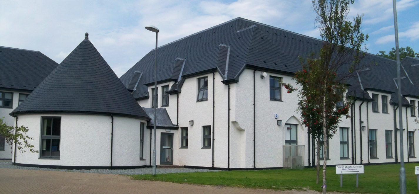 A large white building with a grey roof
