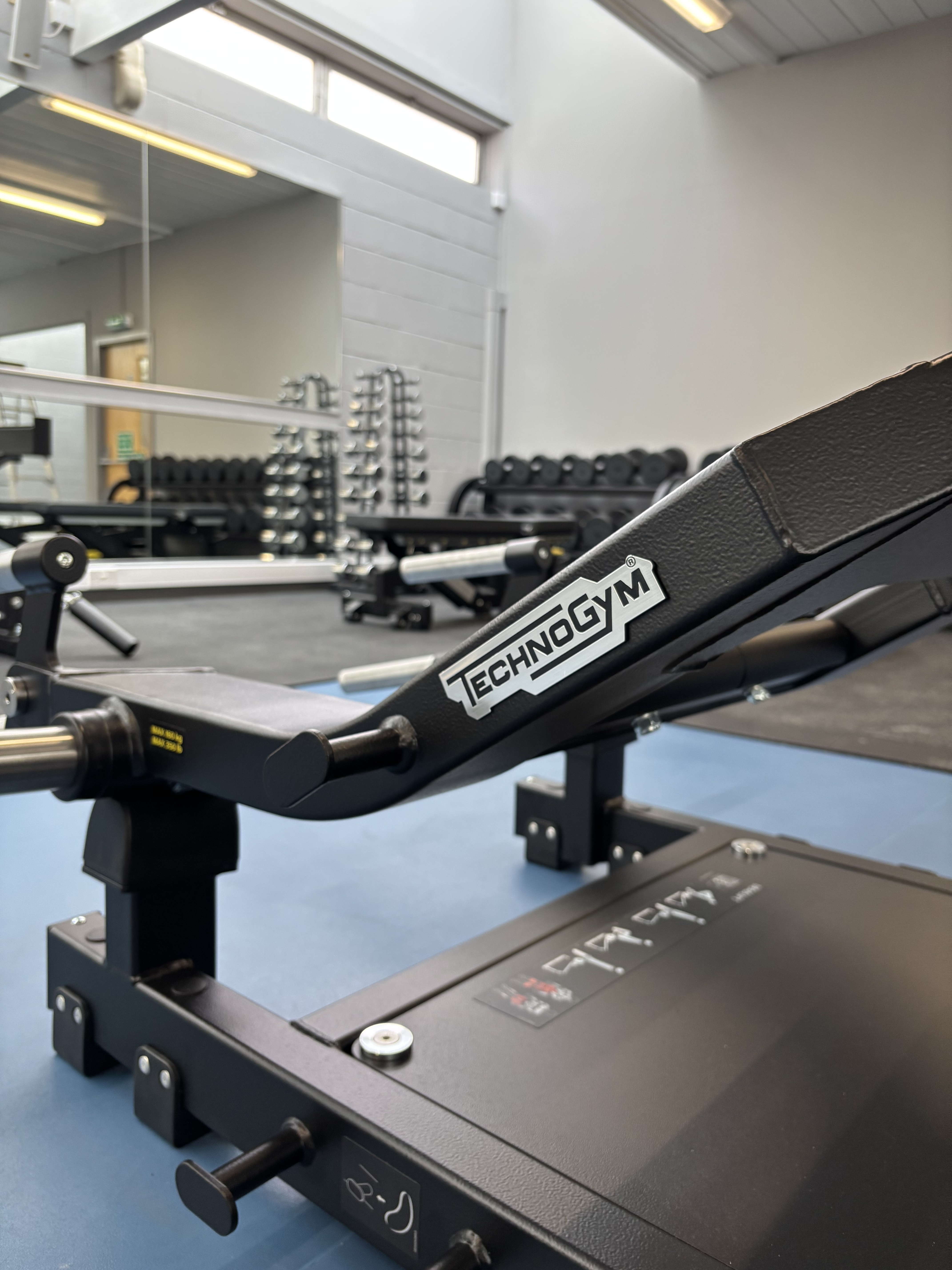 Close up of technogym logo on gym equipment.