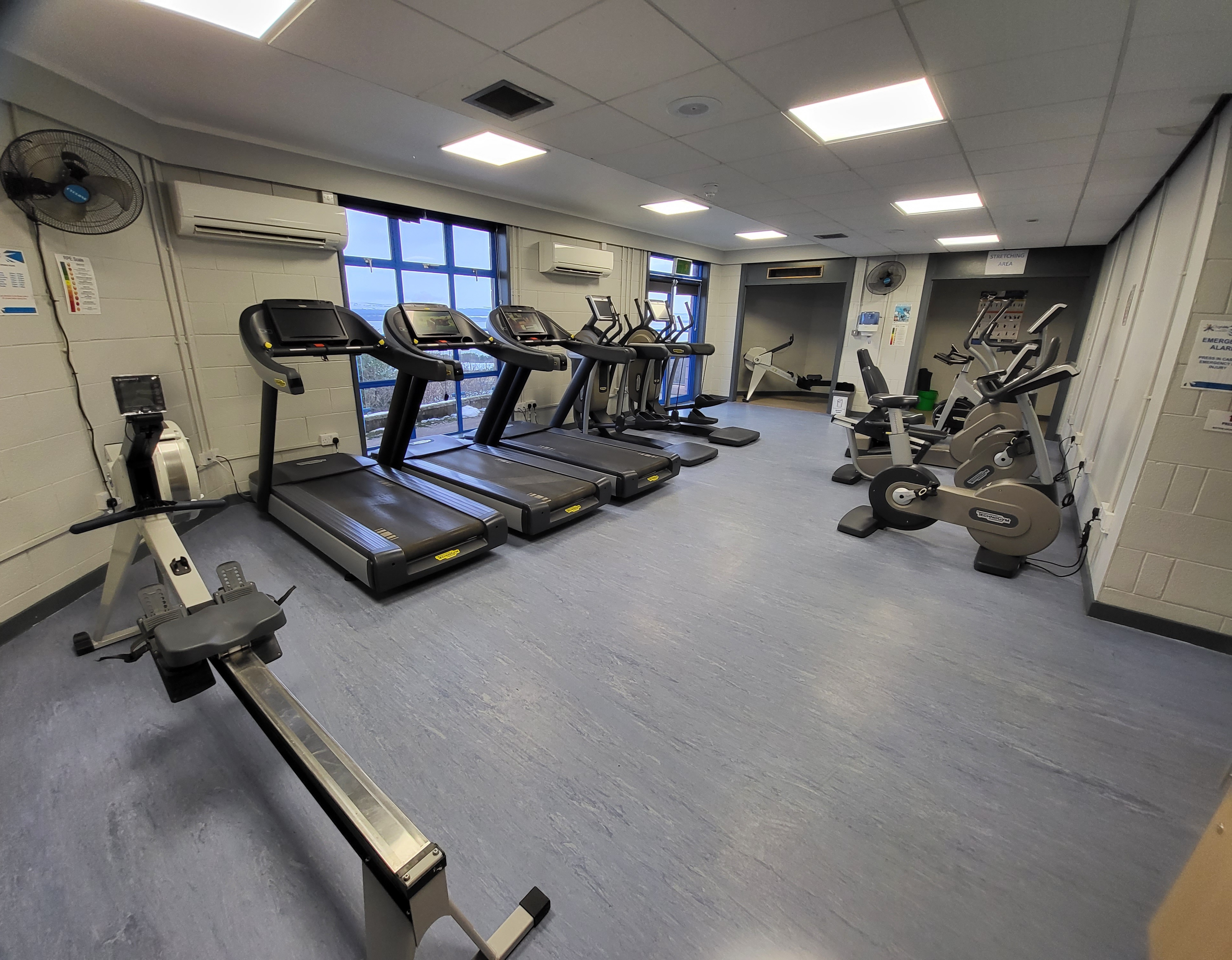 A fitness suite with a rowing machine, treadmills and exercise bikes.