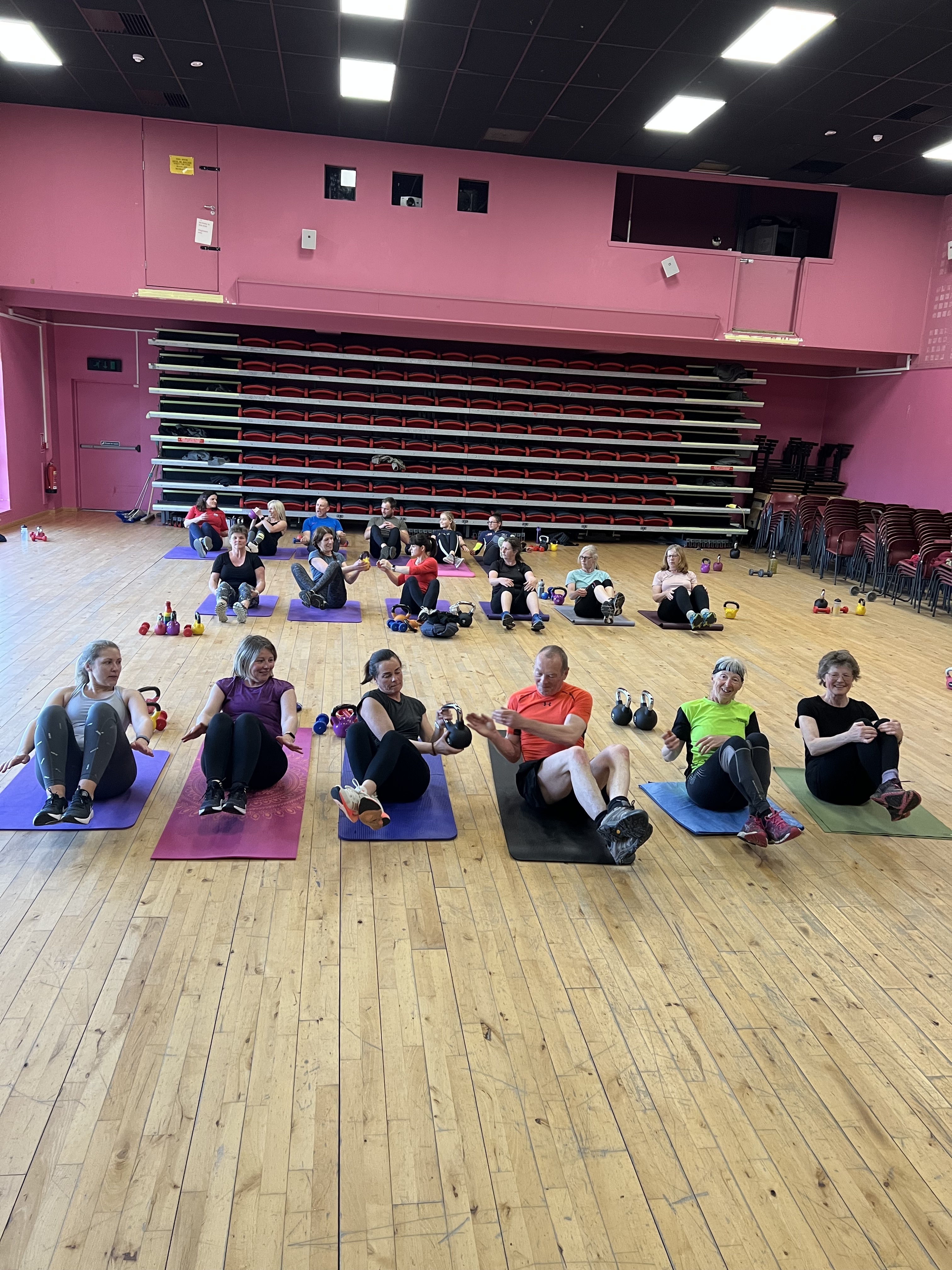 A group of people participating in a group fitness class.