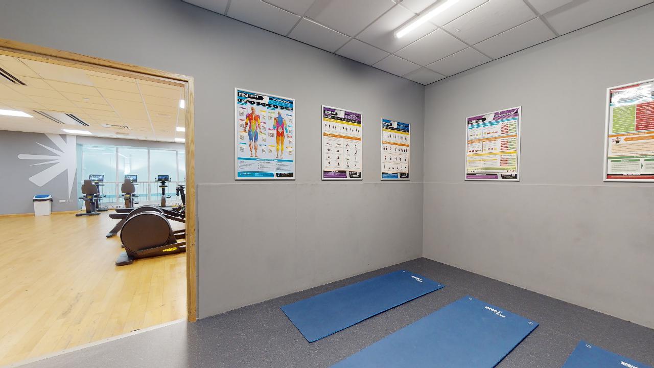 Fitness mats on the floor with door opening to main gym