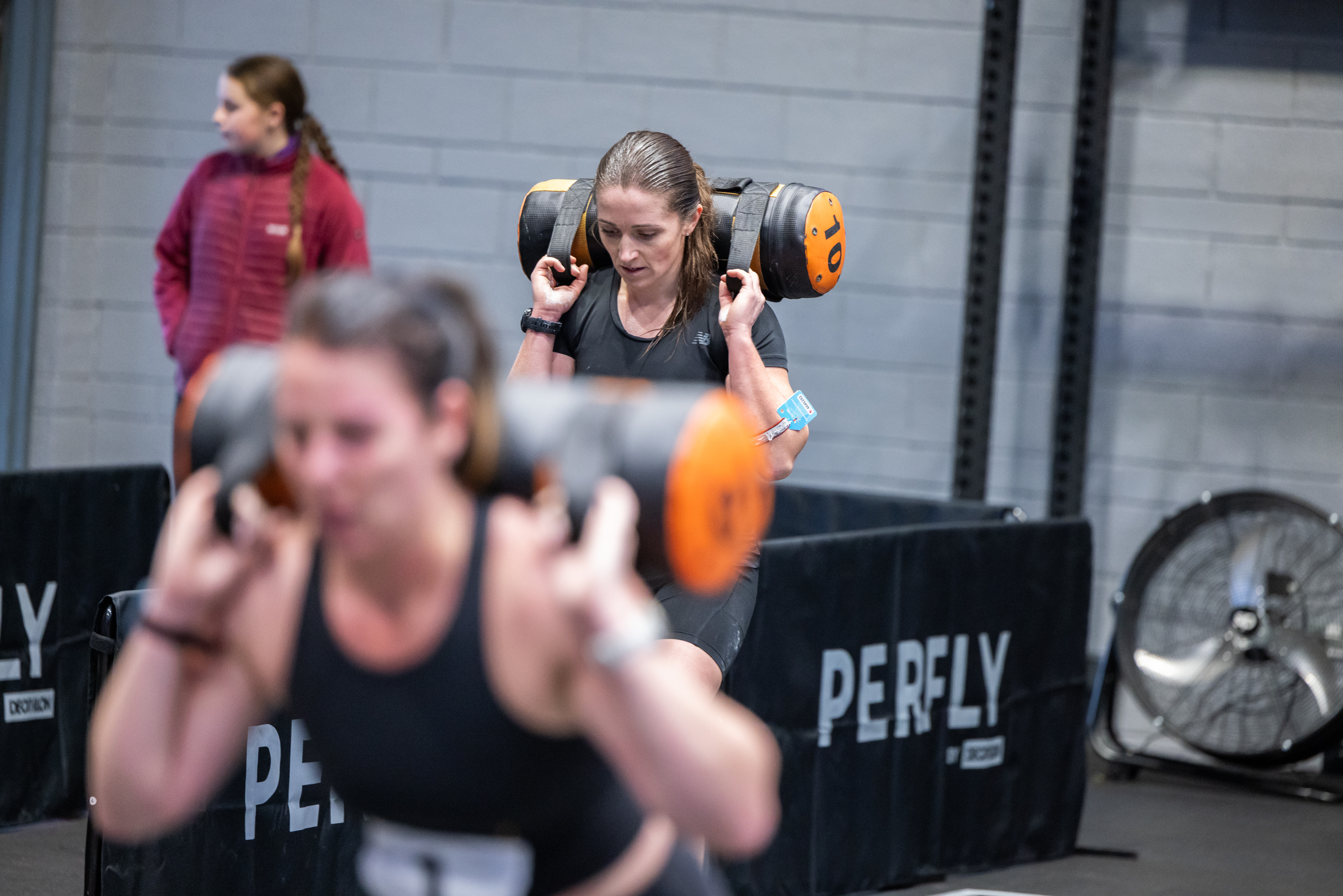 Woman carrying a sandbag during lunges in the HYROX studio at Inverness Leisure