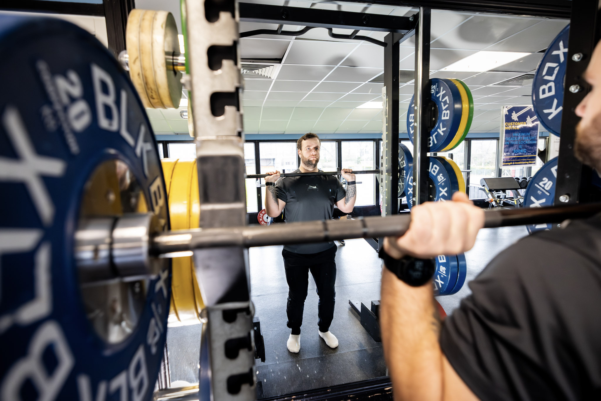 Man performing a front squat with barbell at Inverness Leisure gym