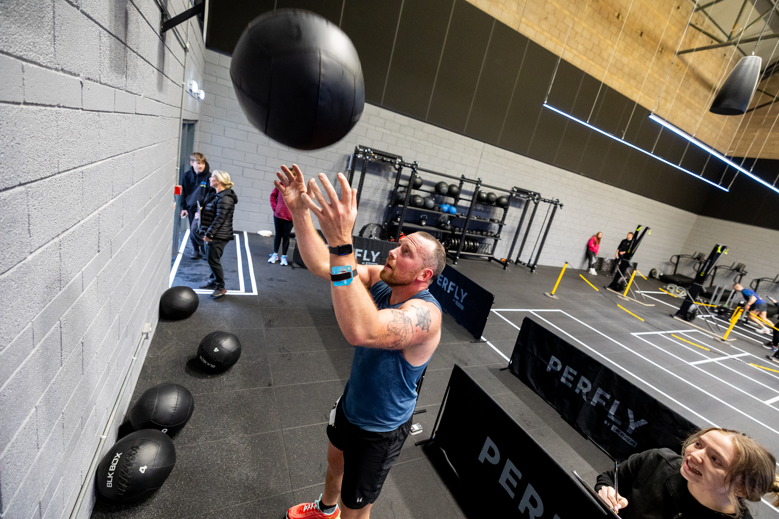 Man throwing a wall ball during a HYROX training session at Inverness Leisure